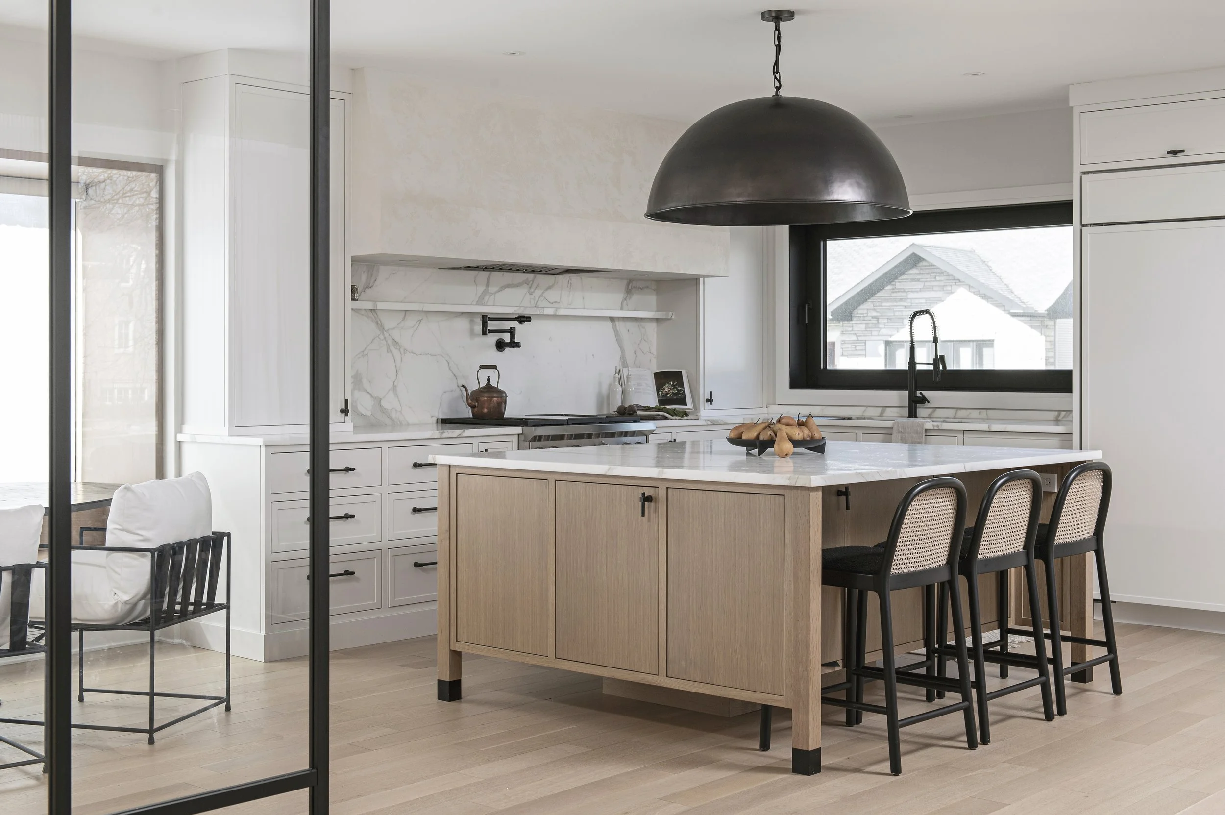 Open kitchen with a wood island and black pendant