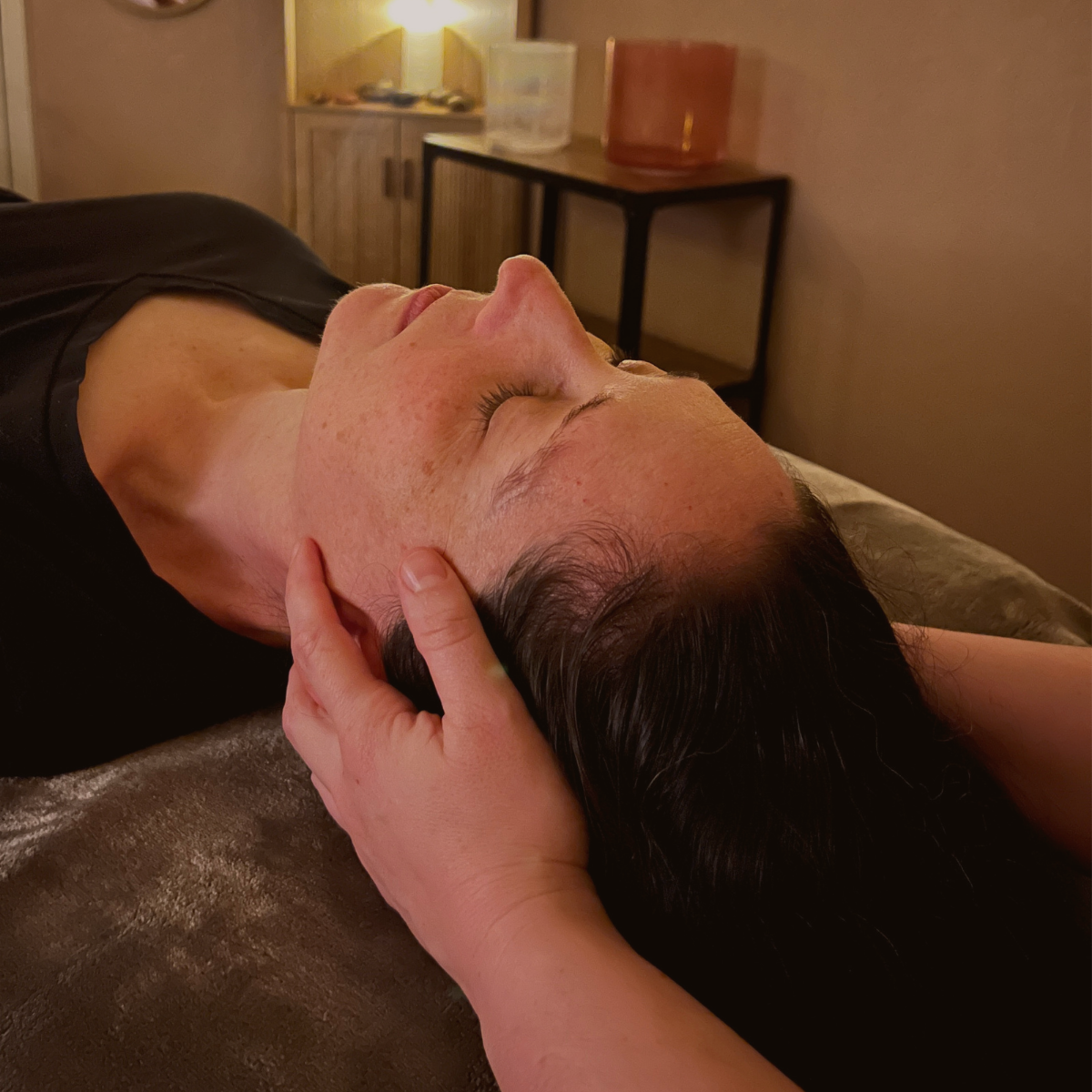 Practitioner performing gentle CranioSacral Therapy to support nervous system regulation.