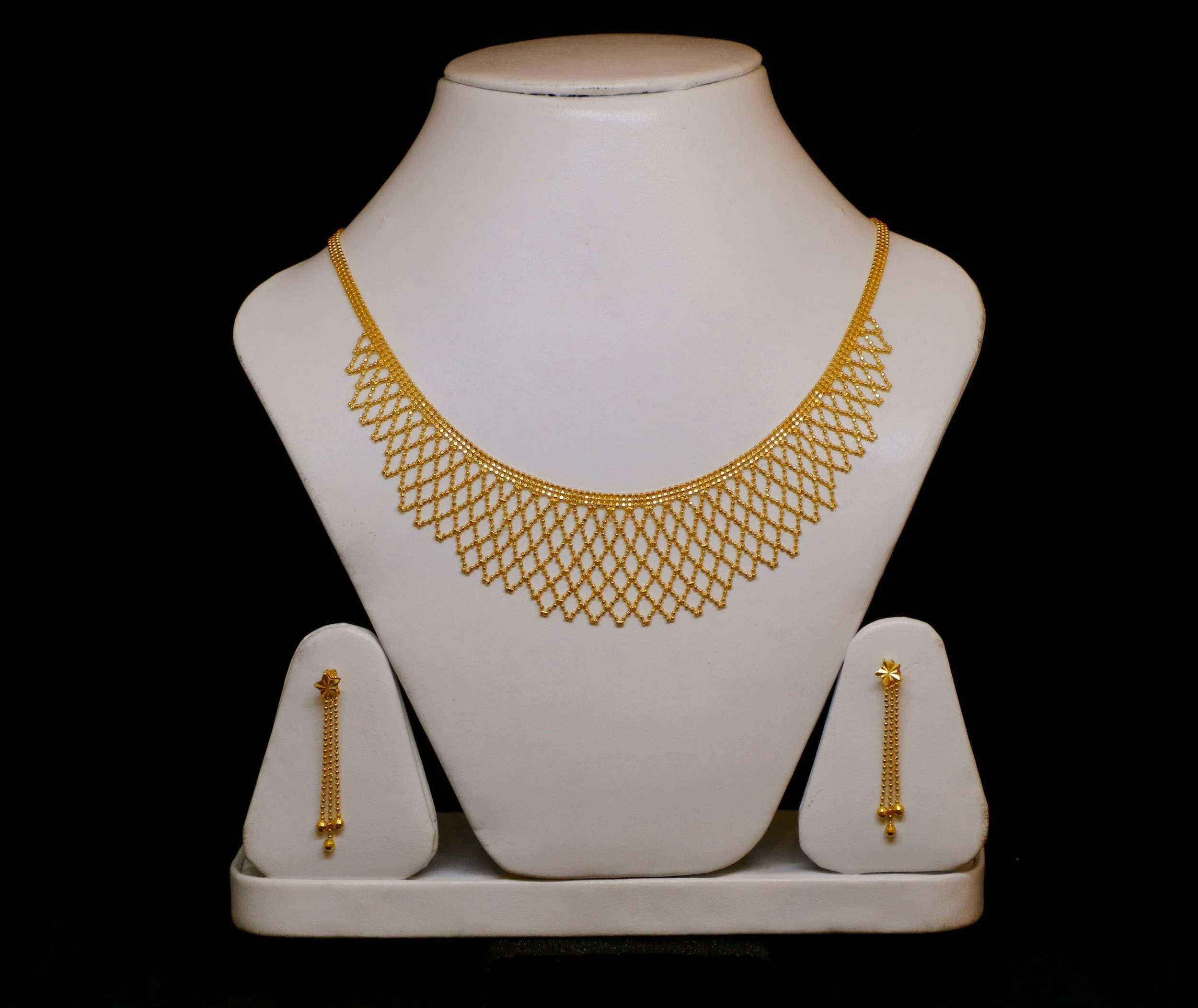 fine jewellery display of gold necklace and earrings