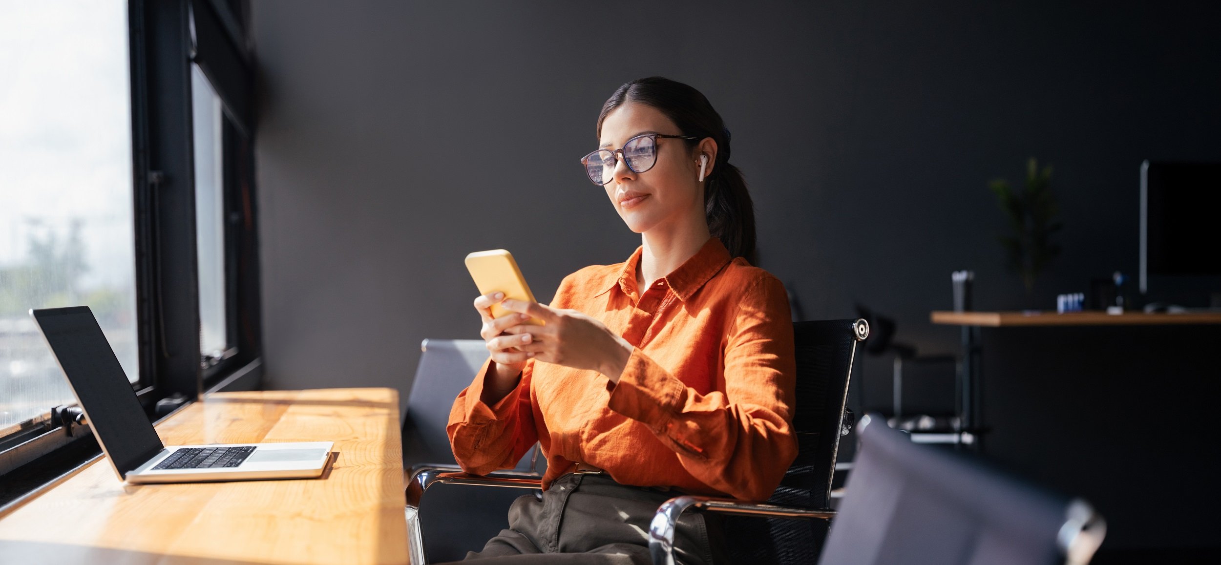 Young business woman manager ceo using cell phone mobile app laptop