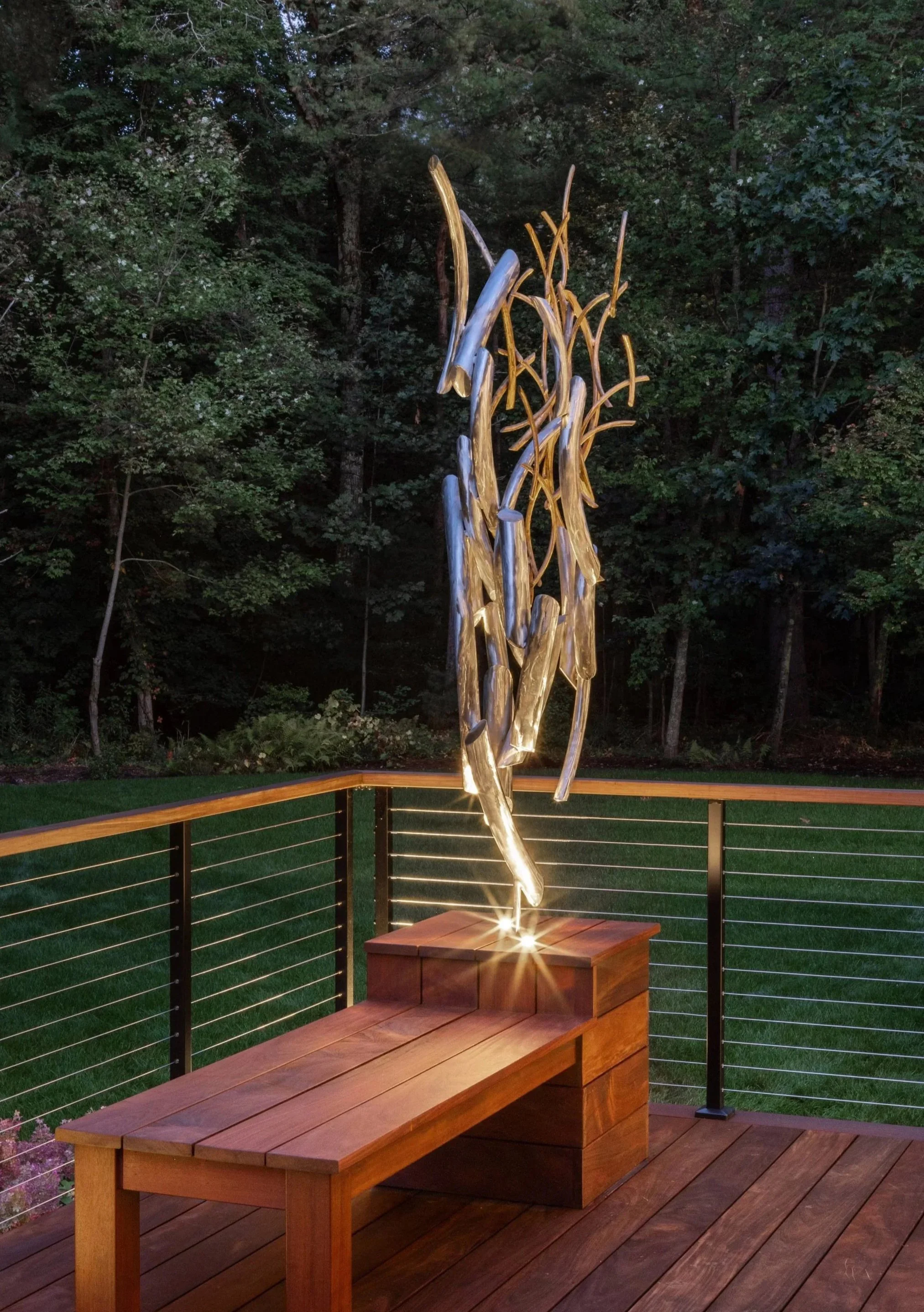 Abstract stainless and bronze shapes create upwards momentum.