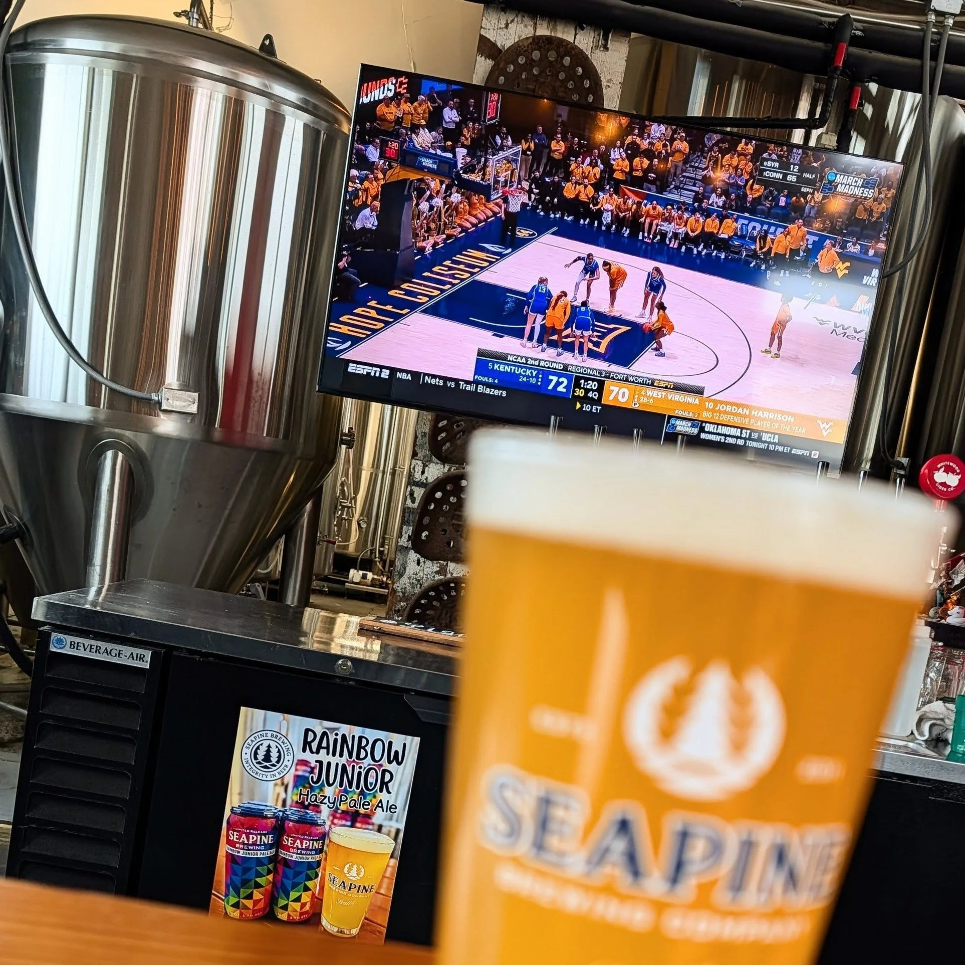 New tv behind the bar at the tasting room! 👀 Come in and catch some March Madness this week!