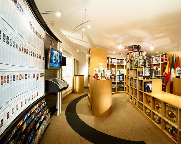 Bookshelf and display area in a bookstore, with flags in the background.