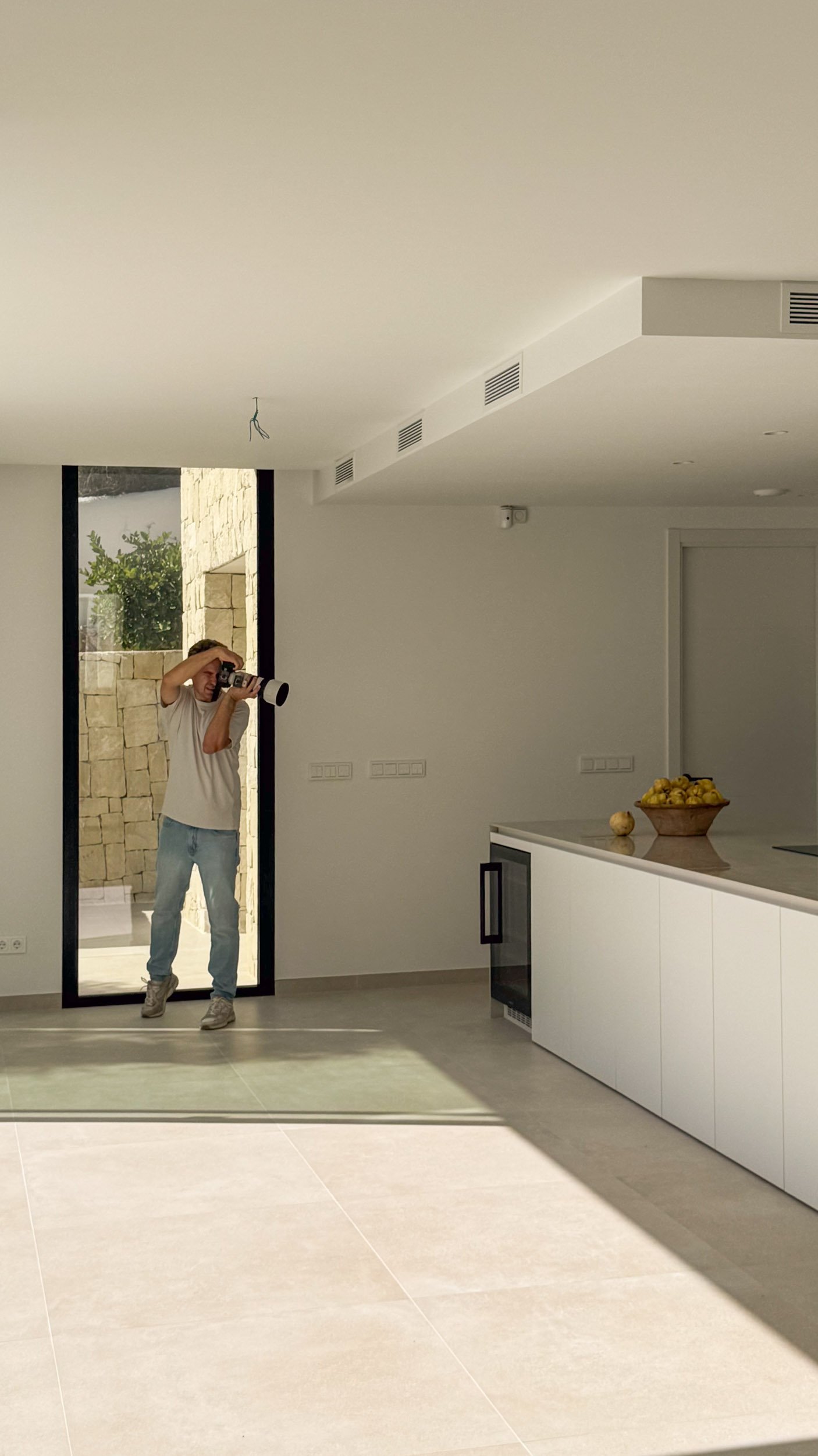 Interior photographer Marcin Leszczynski framing a shot through the camera viewfinder during a photoshoot.