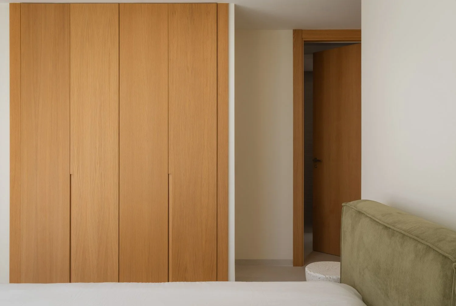 Detail of custom oak wardrobe doors in a modern bedroom.