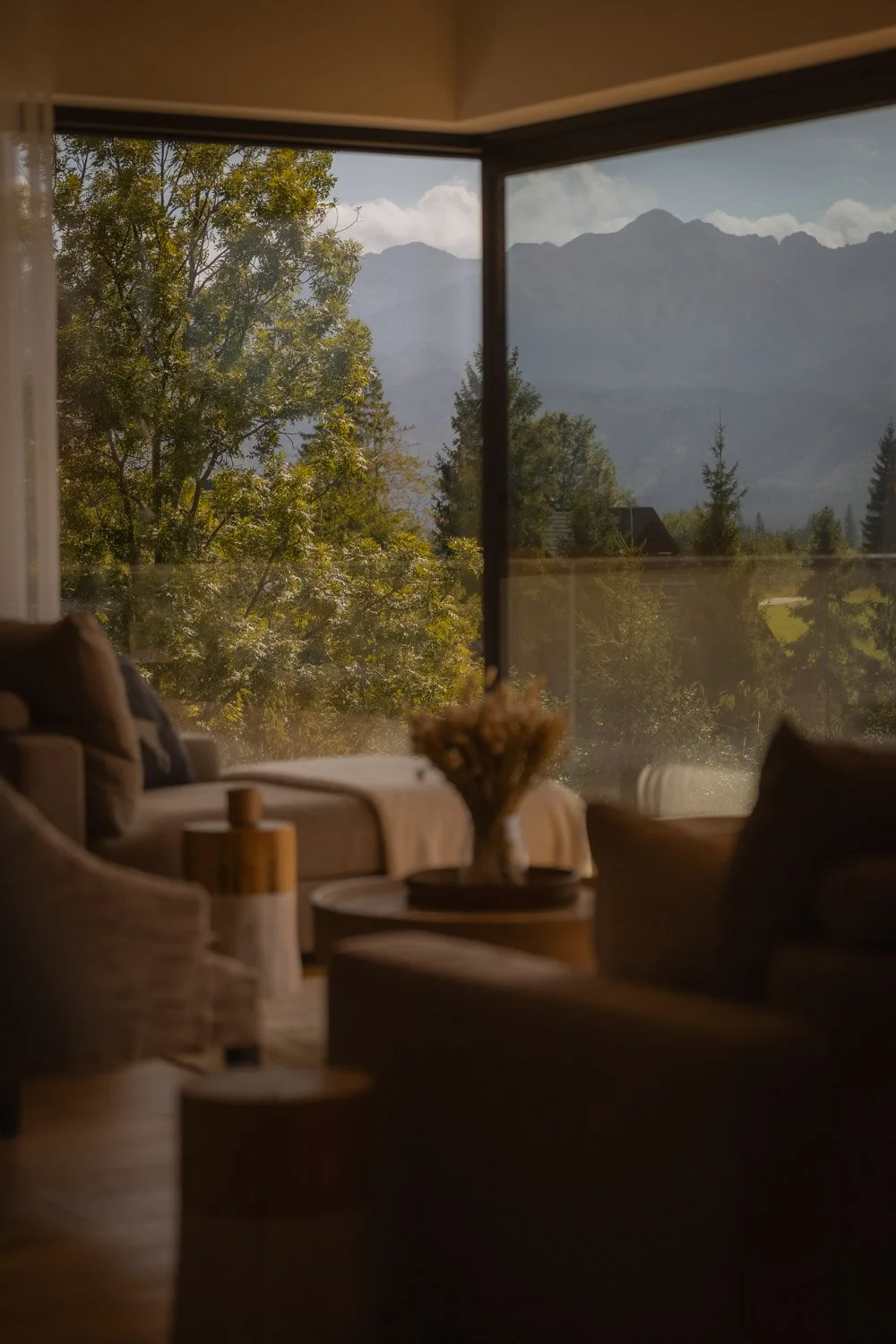Minimalist living room framing a cinematic view of the Tatra Mountains peak