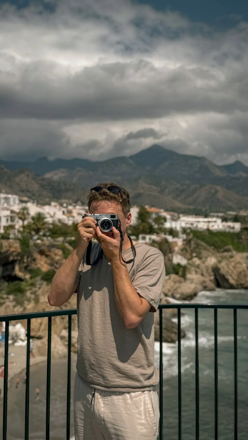 Architectural photographer Marcin Leszczyński capturing a coastal landscape with a vintage camera.