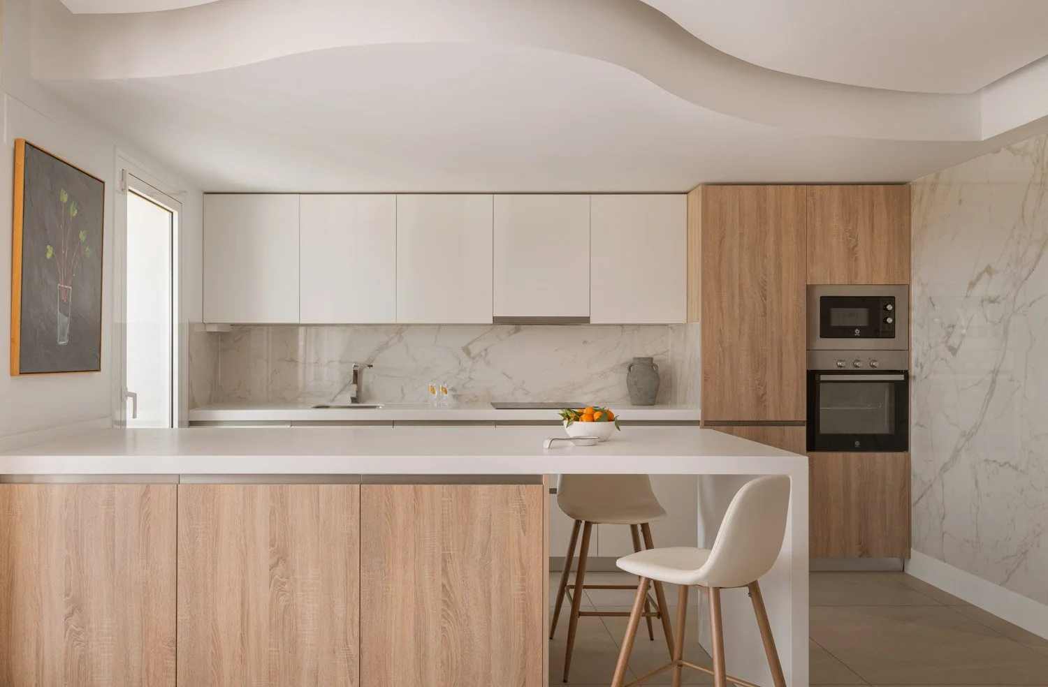 Modern kitchen interior with white and wood cabinetry and an island