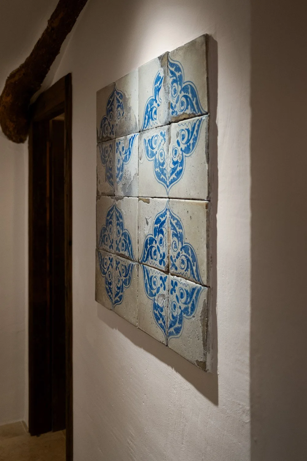 Antique blue and white azulejos tiles preserved on lime plaster wall in Altea historic residence