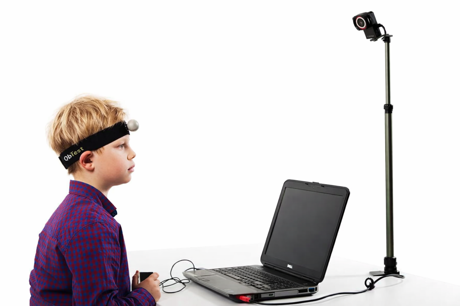 Child taking a QbTest for ADHD while motion tracking equipment measures attention and activity