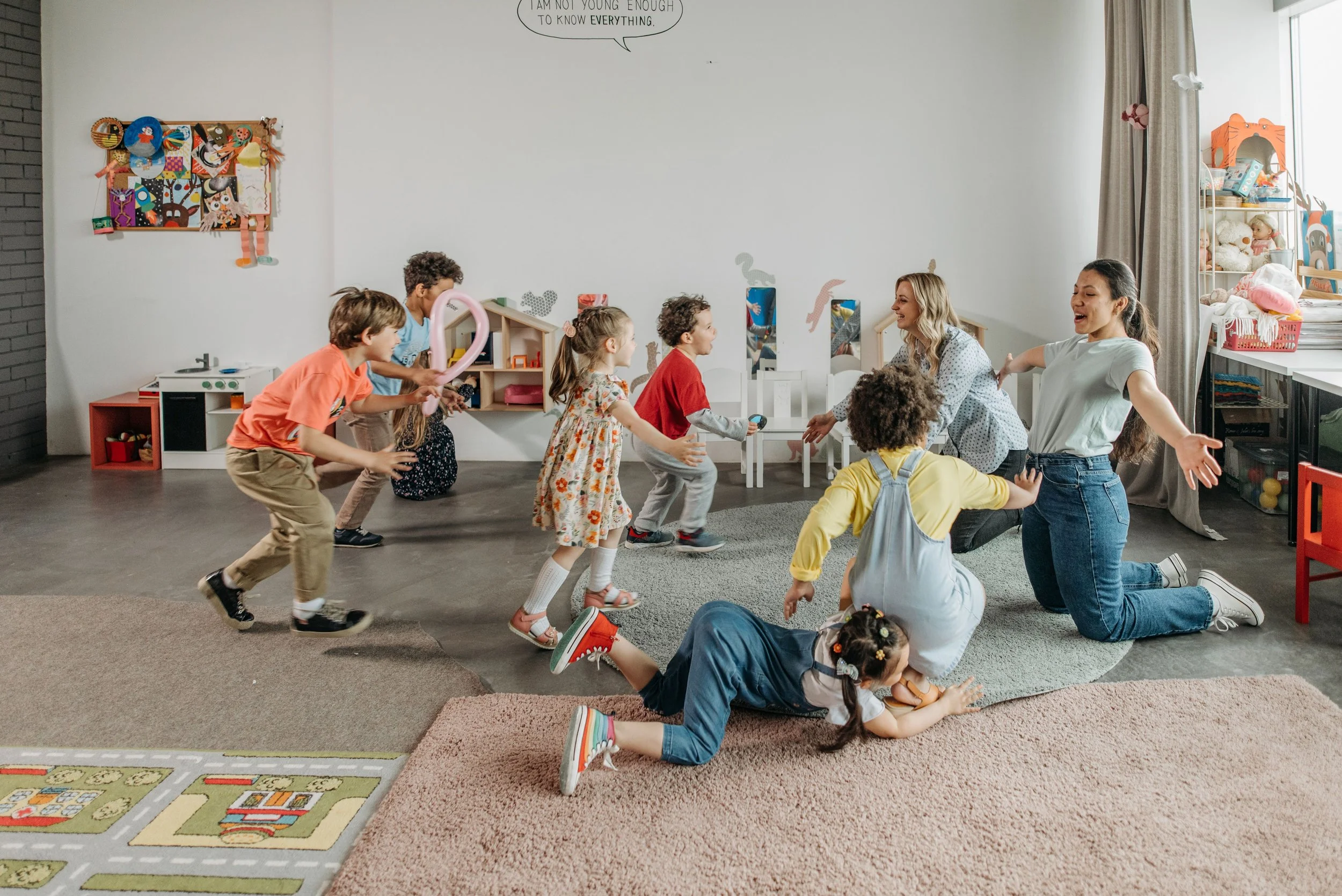 Children participating in a playful mindfulness activity with teachers in a classroom