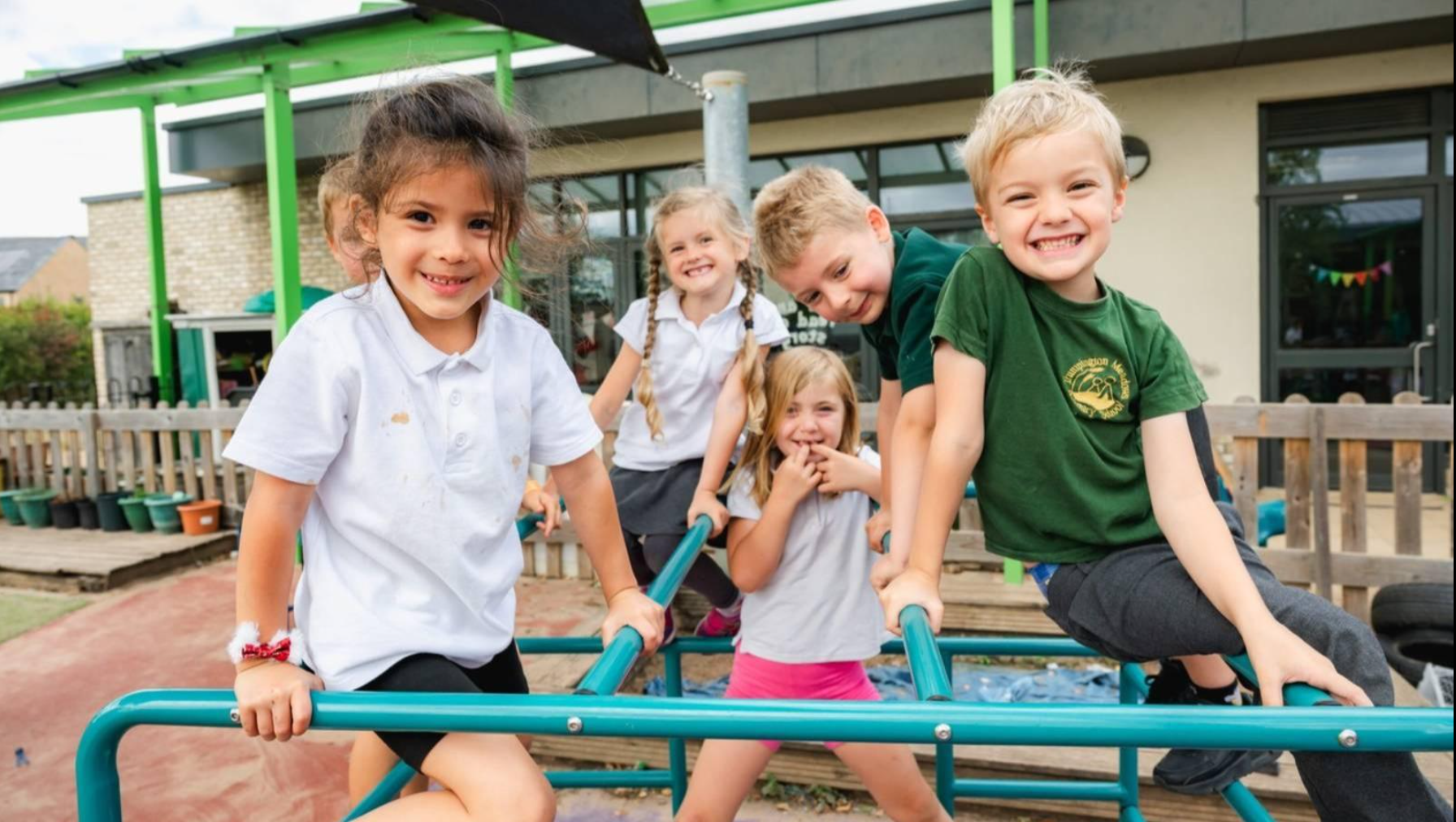 Children smiling and playing together on an outdoor playground
