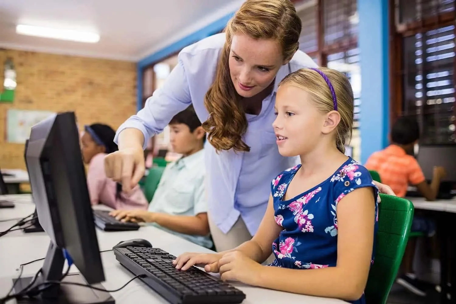 Student completing a virtual psychoeducational assessment at school with teacher support
