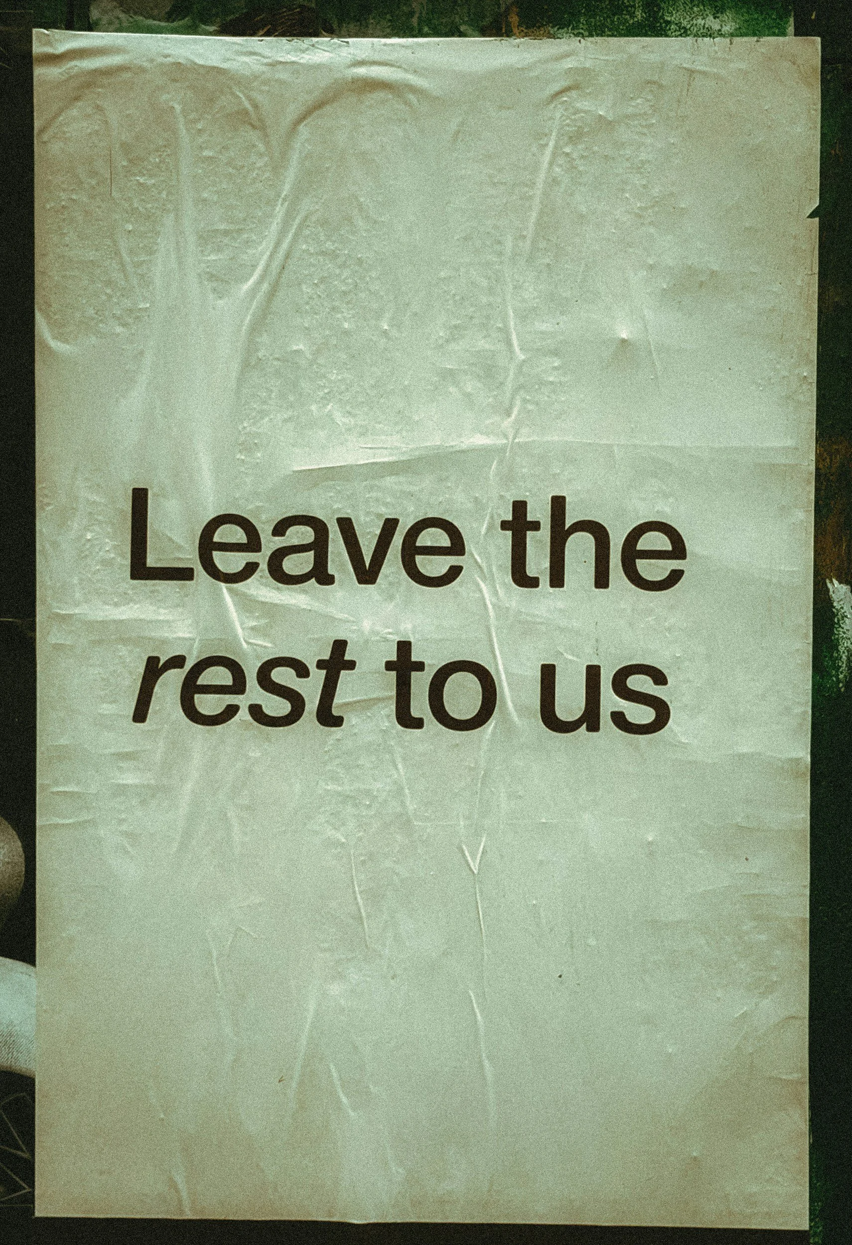 A sign with the words "Leave the rest to us" printed on it.
