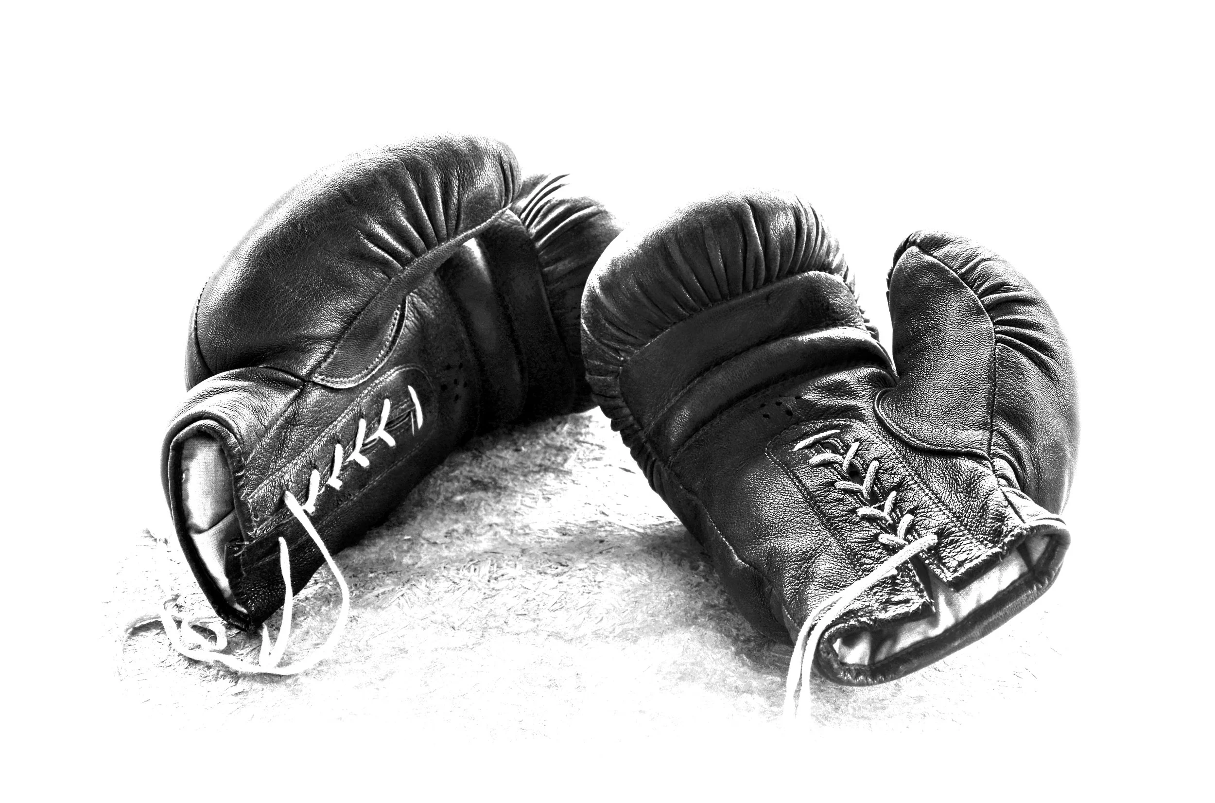 A pair of black boxing gloves on a white background