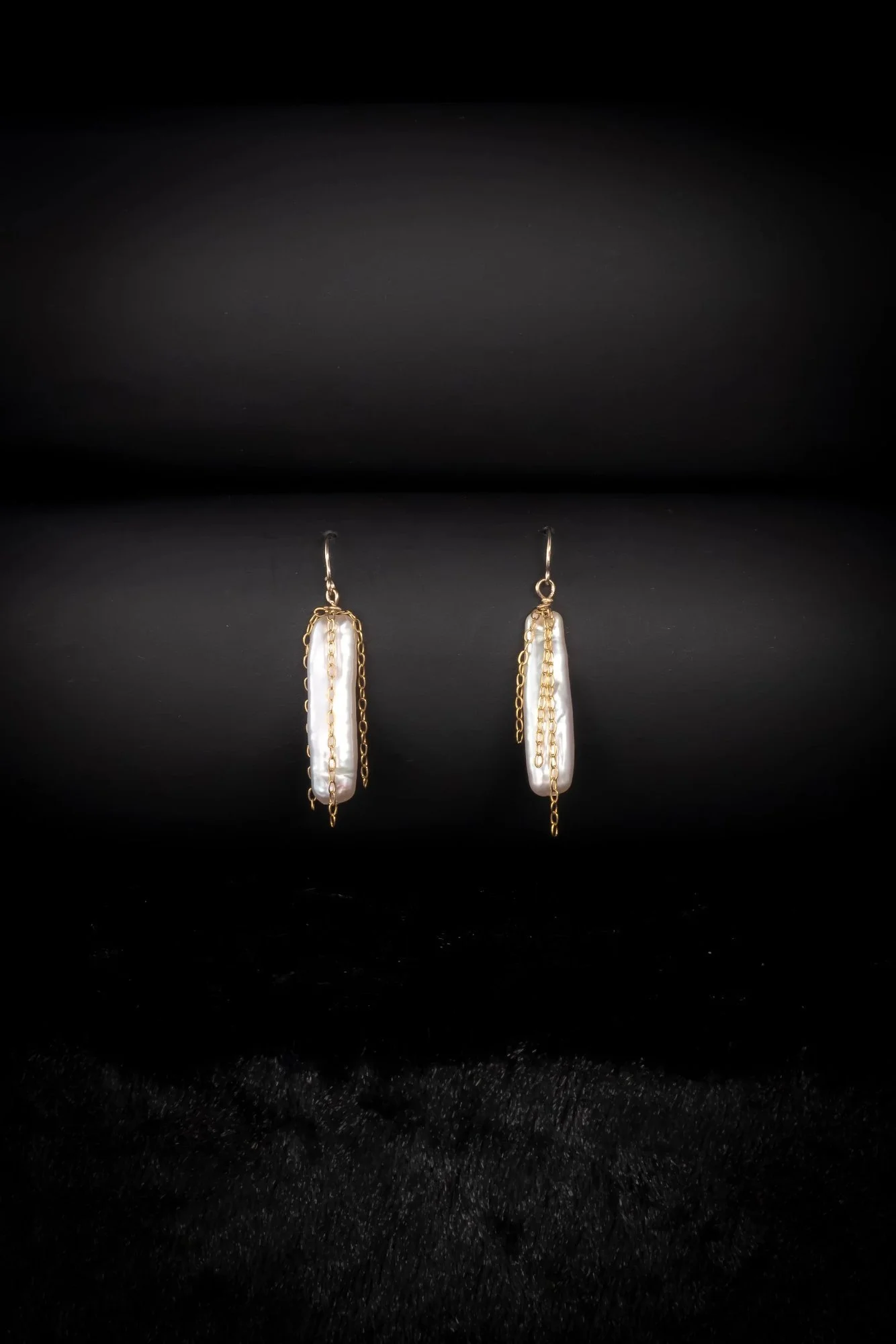 Loki's Nets; Slender, sleek pearls wrapped in fine gold chain create an eye-catching  look.