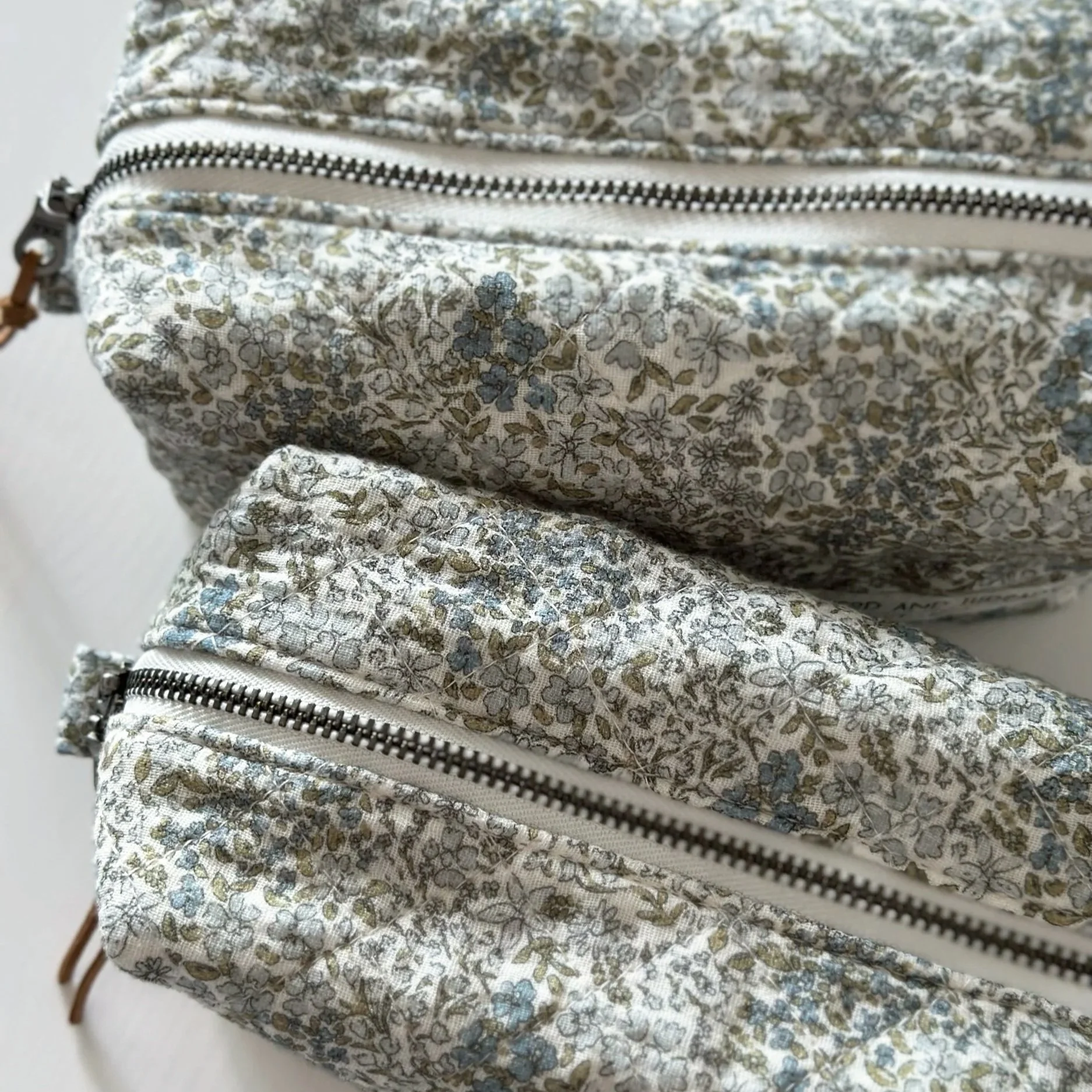 Slim green crosshatch quilted pouches from the Morning Mist collection