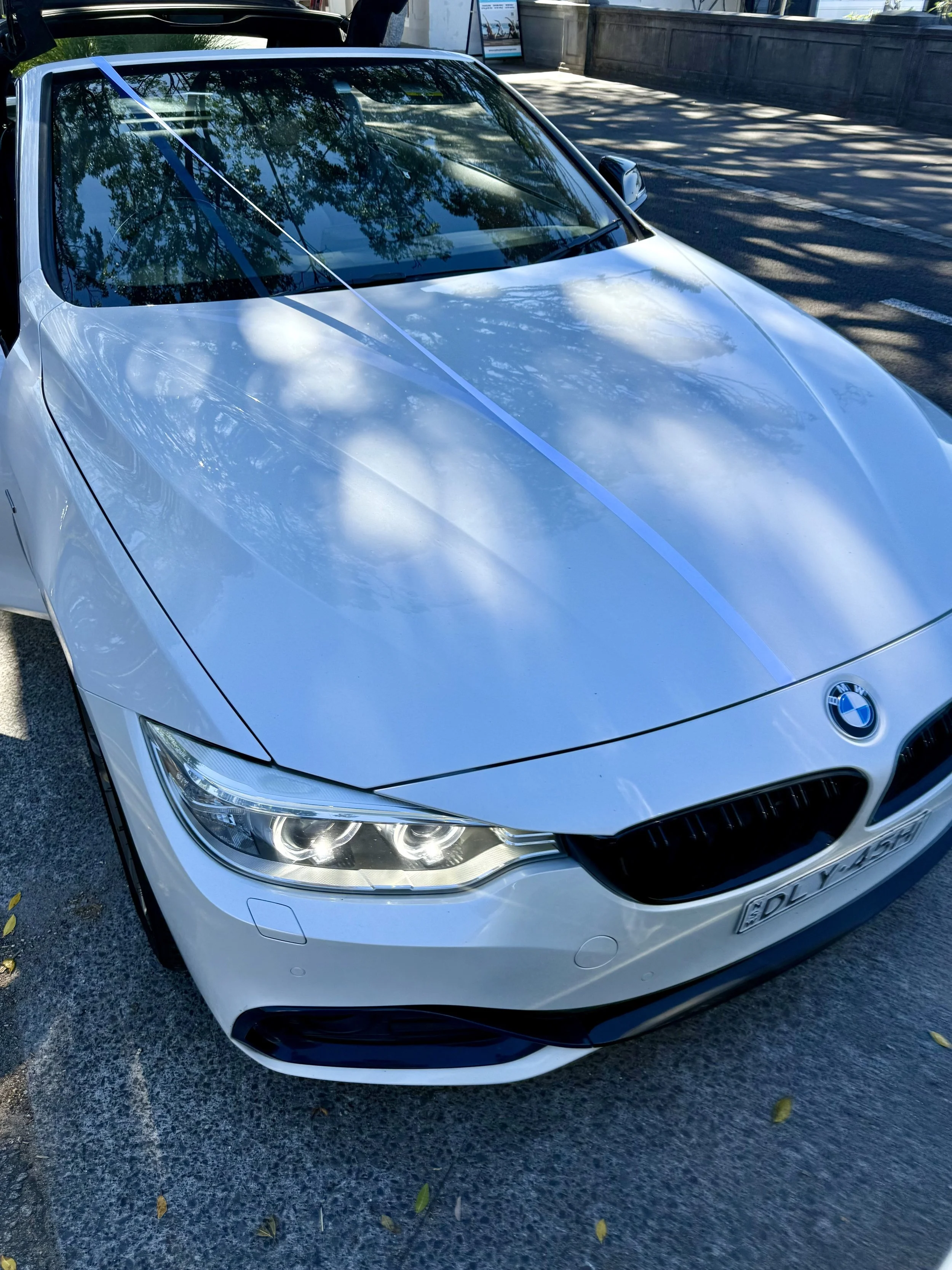 white wedding ribbon on white convertible bmw