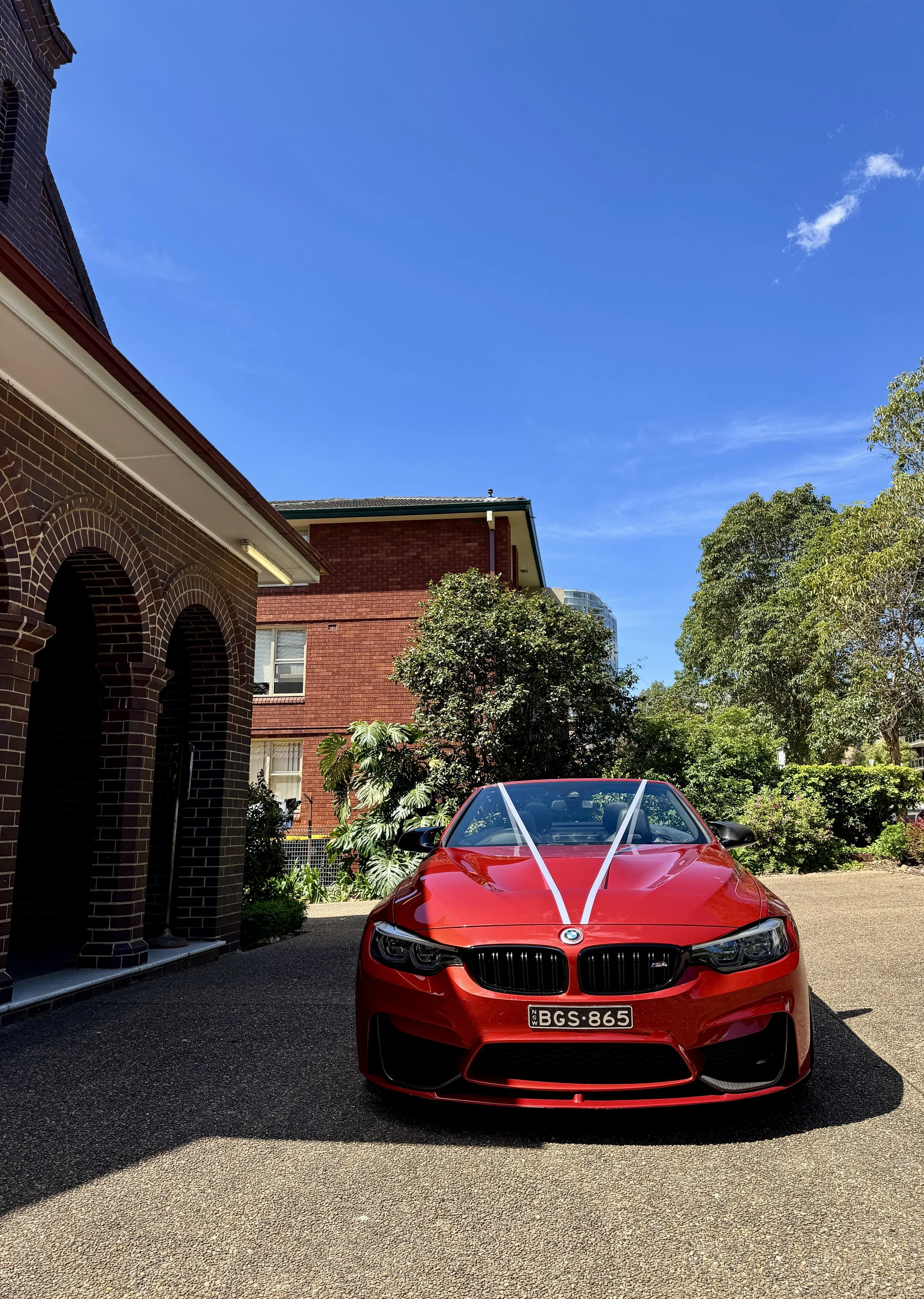 white wedding ribbons on white convertible bmw