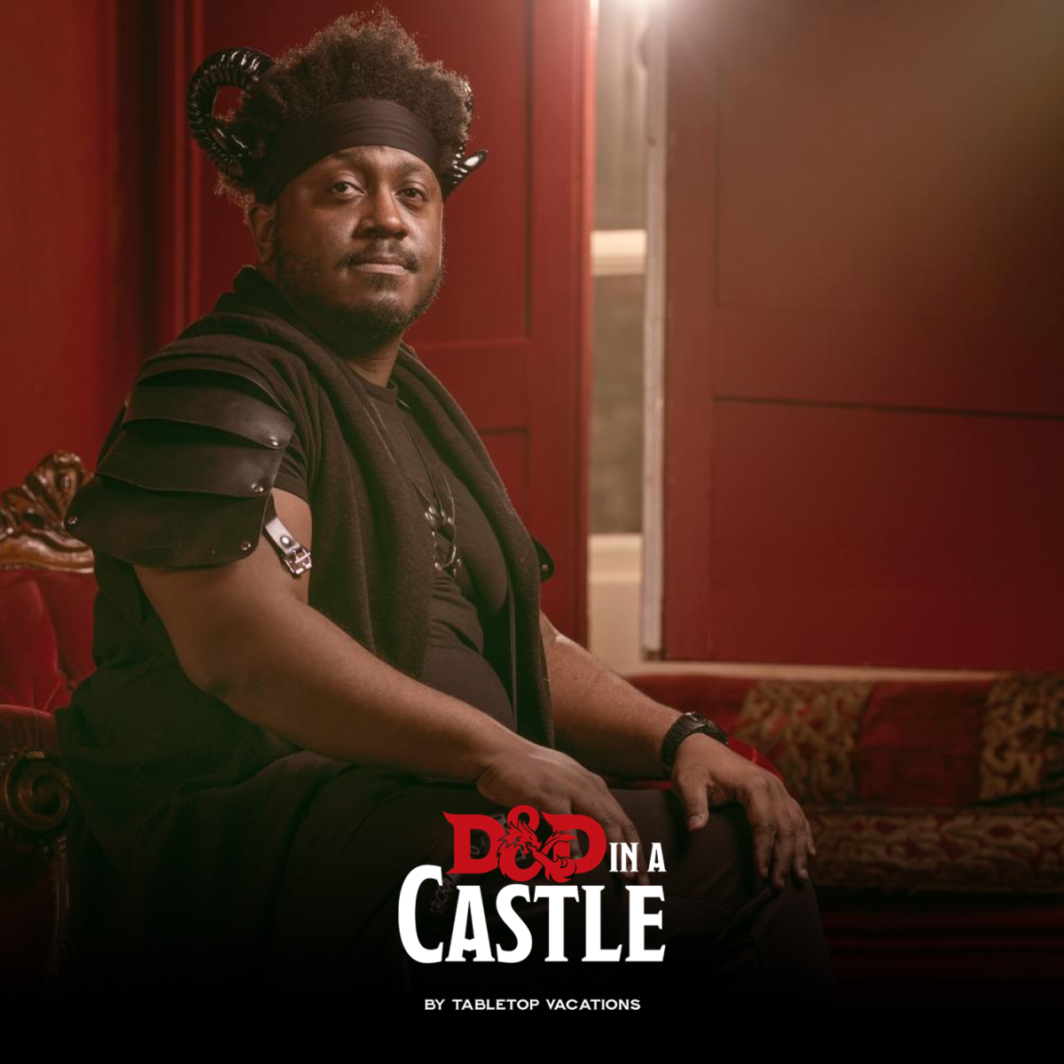 Male sat down in front of red doors