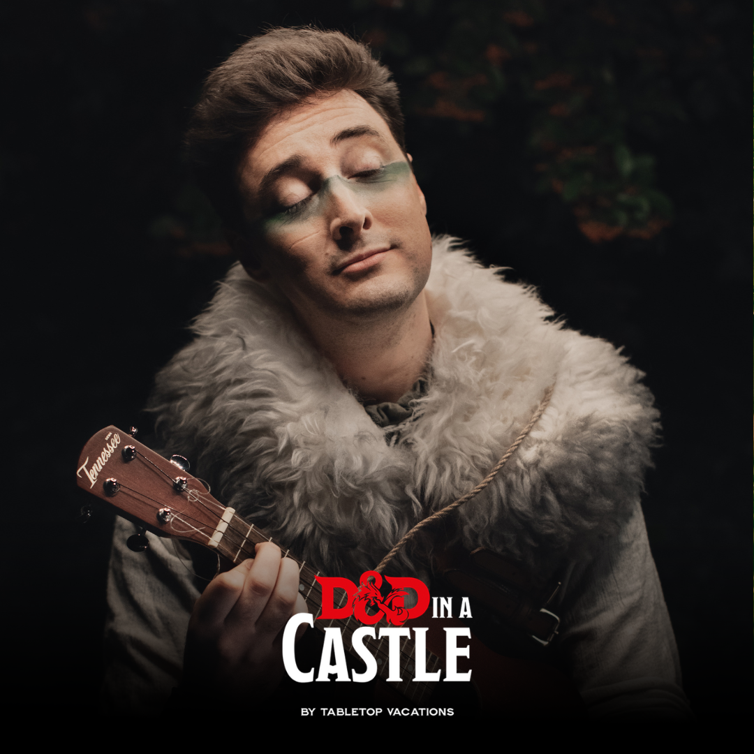 Male headshot holding string instrument