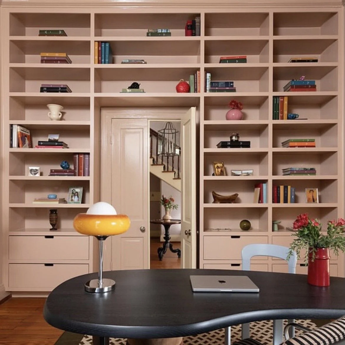 Pink built-in book case.