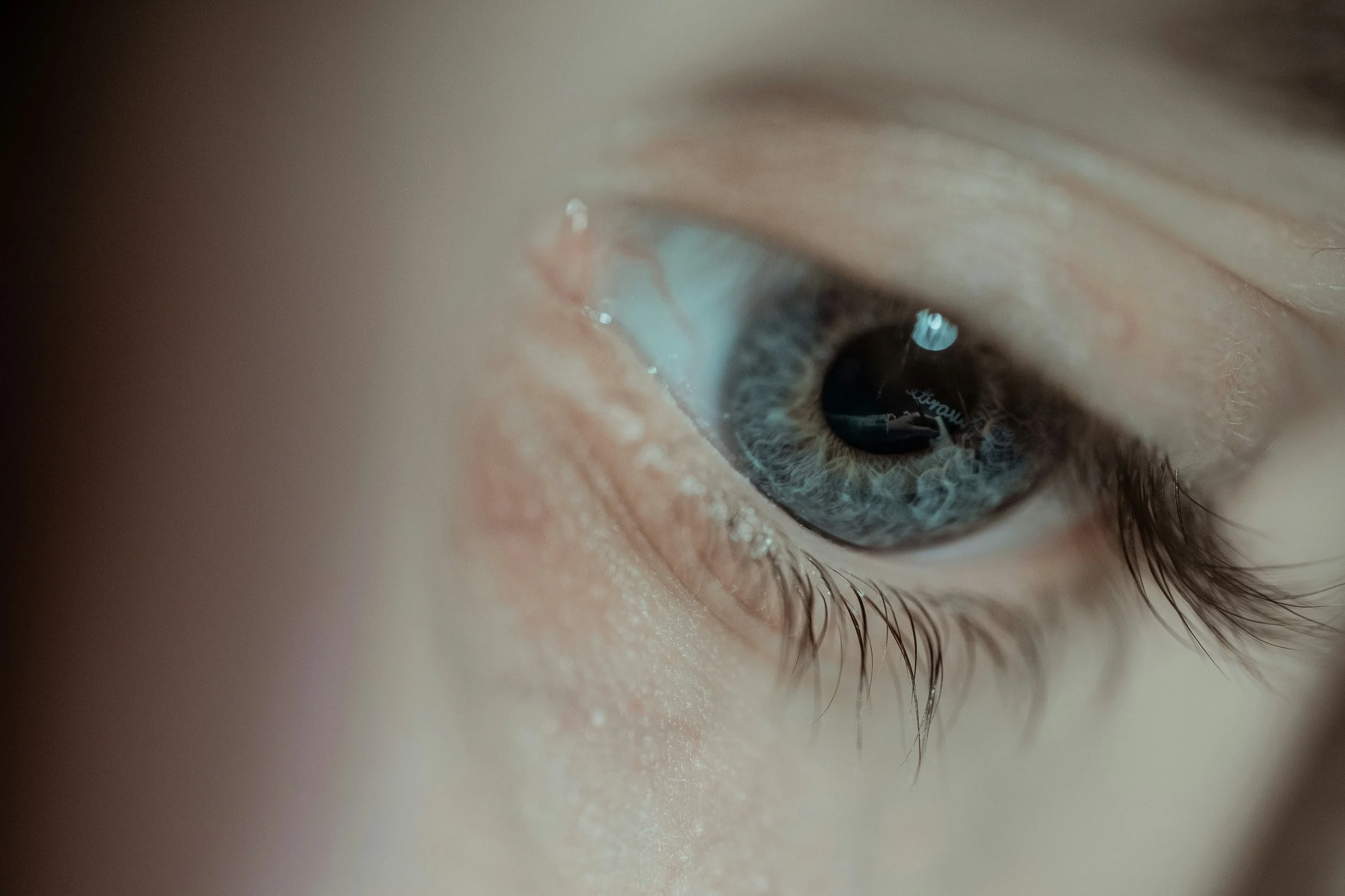 A single eye looking downward.