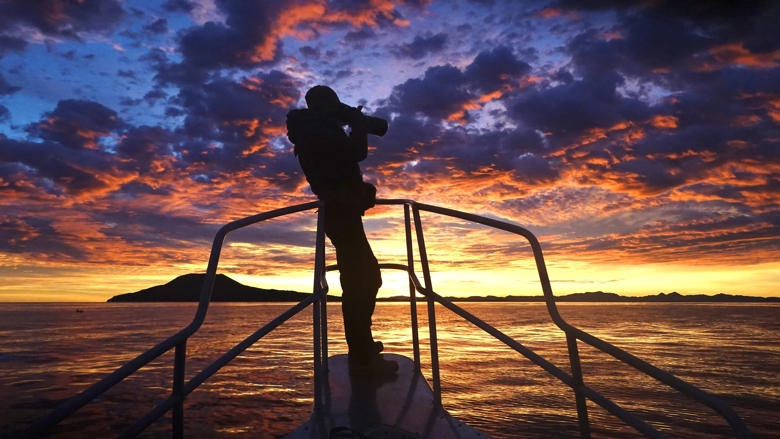 La Puma whale-watching boat with wildlife photographer on the observation bow in Loreto