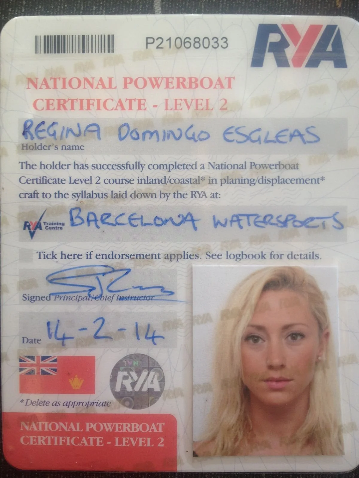 A certificate titled 'National Powerboat Certificate - Level 2' issued by the Royal Yachting Association (RYA), with a photo of a blonde woman and handwritten details including name 'Regina Domingo Eglesas', endorsement 'Barcelona Watersports', date 