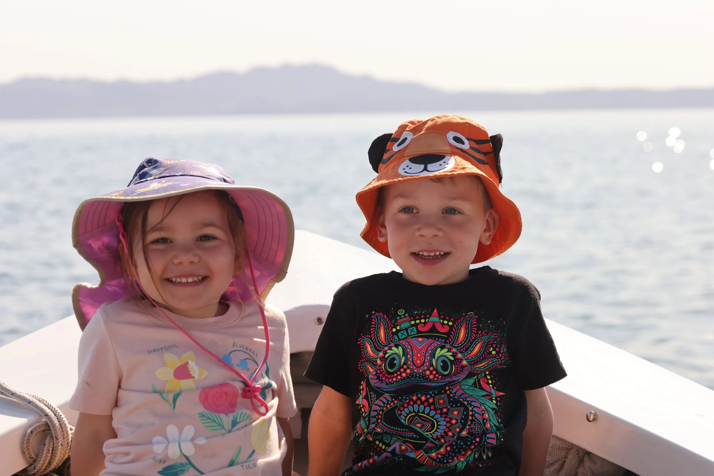A family boat ride on the water during sunset, in the crystal-clear waters of Loreto Bay National Park with Baja Adventures.