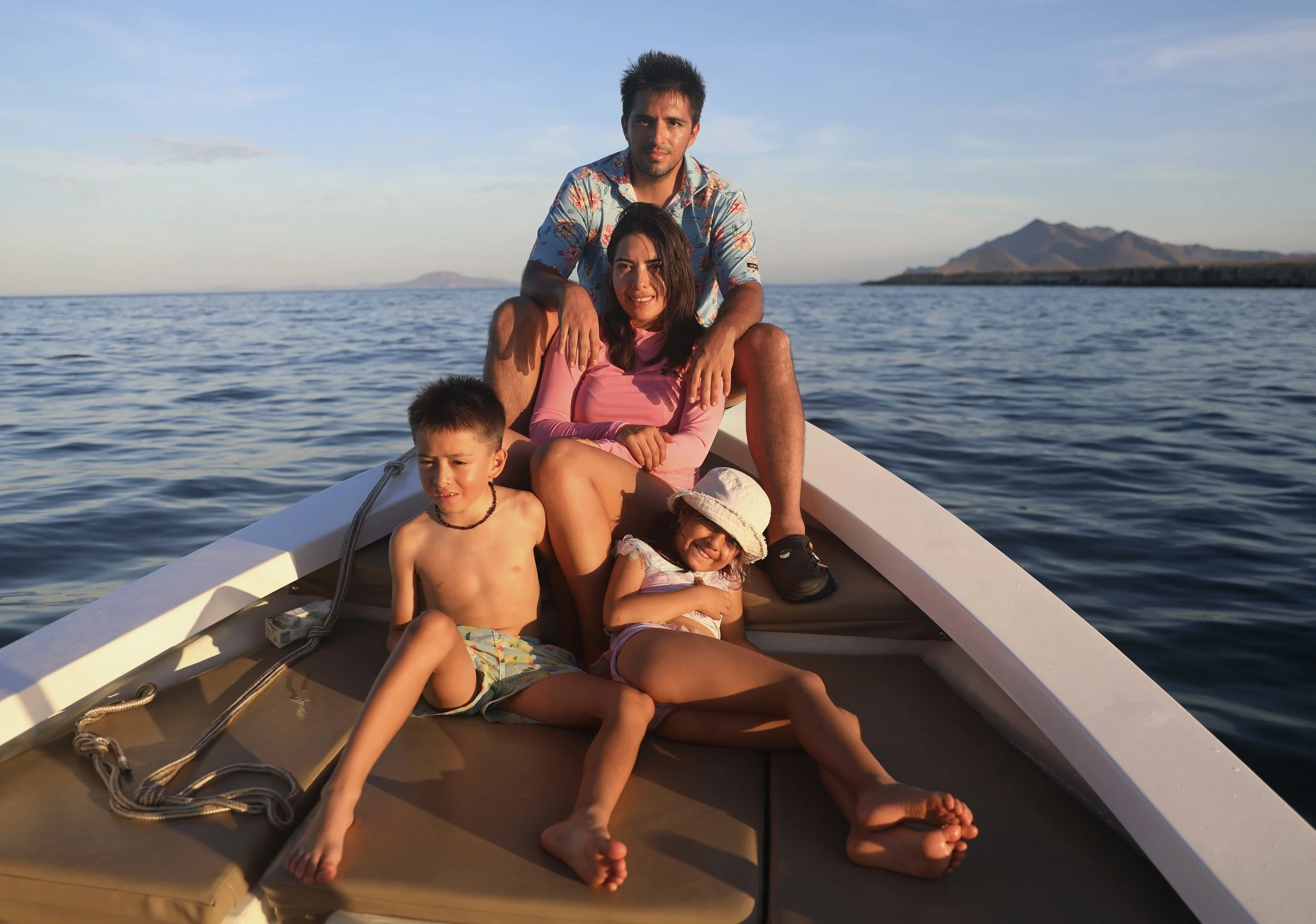 A family  boat ride on the water during sunset, in the crystal-clear waters of Loreto Bay National Park with Baja Adventures.