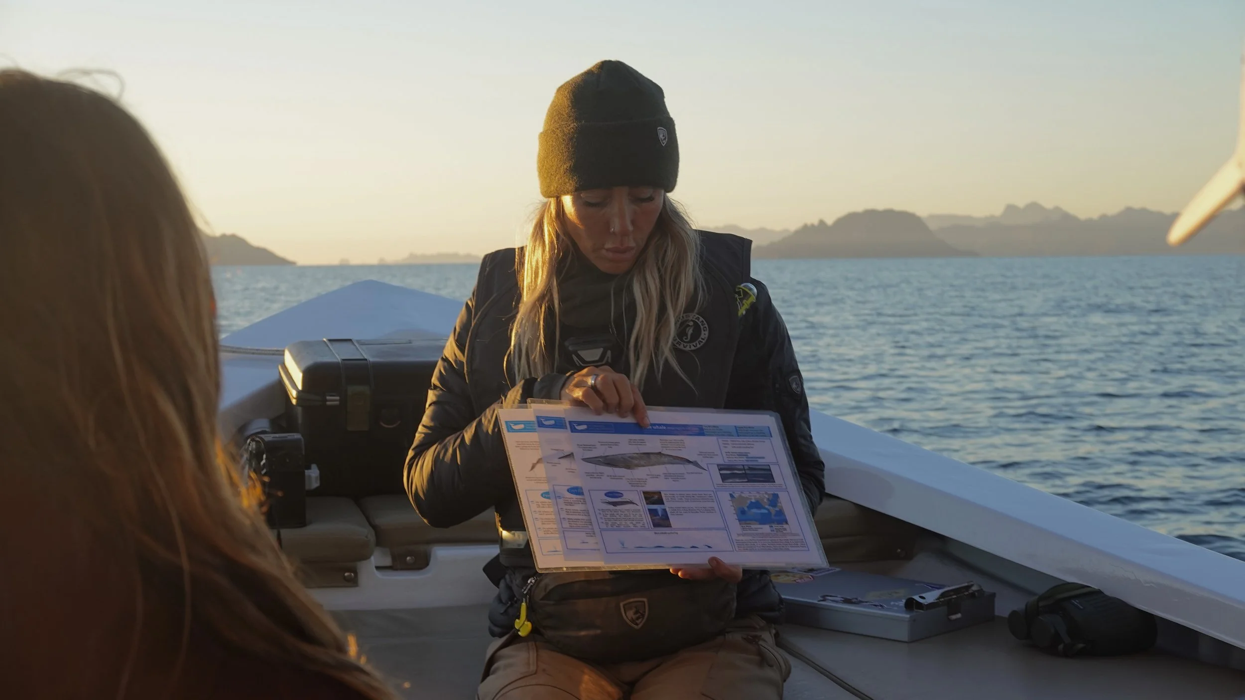 Expedition leader Regina Domingo sharing blue whale ecology and behavior with participants during a whale-watching expedition in Loreto.