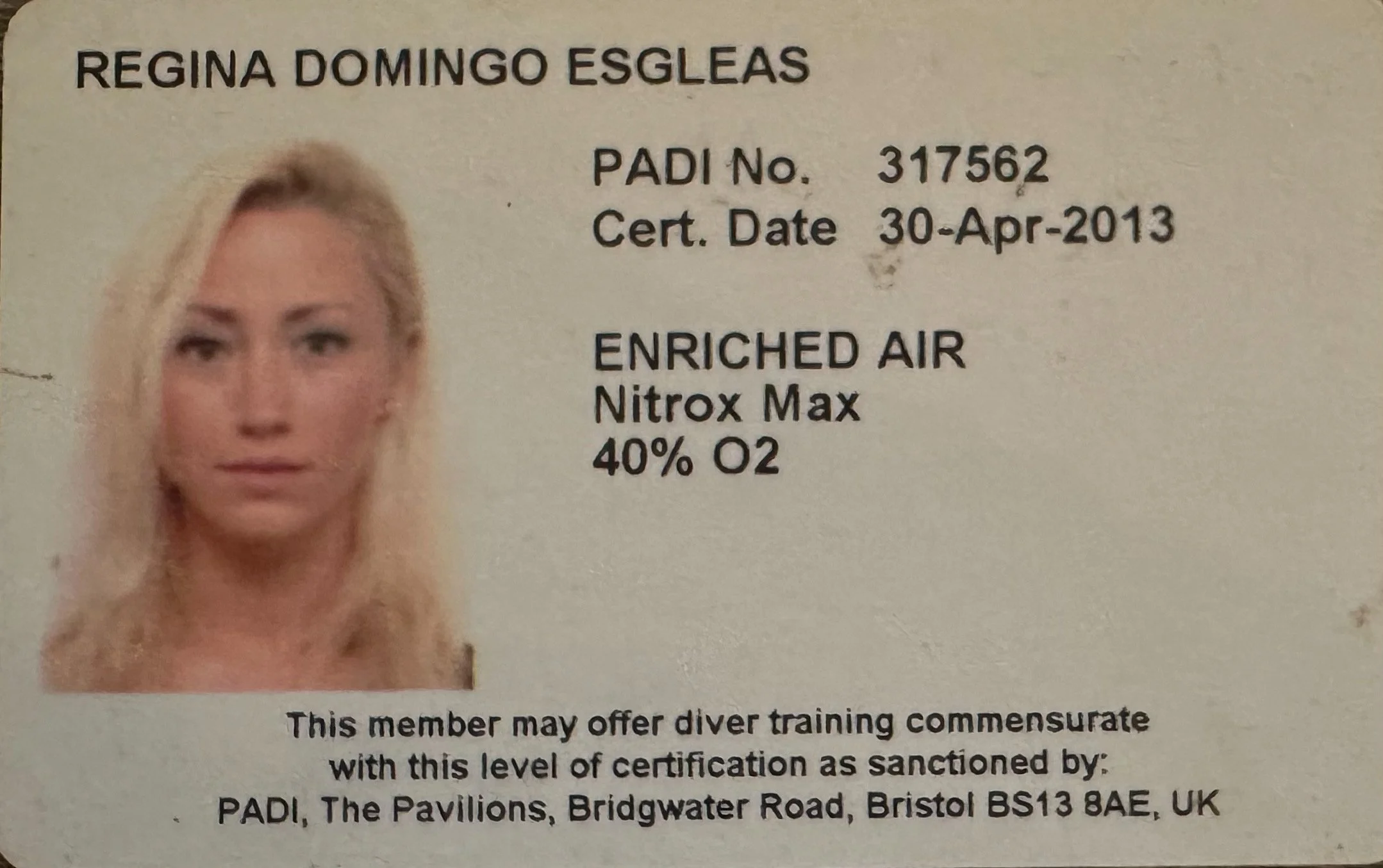 Scuba diving certification card belonging to Regina Domingo Esgleas, featuring her photo and diving certification details. The card indicates her PADI number, certification date, and that she is certified for enriched air with max nitrogen and oxygen