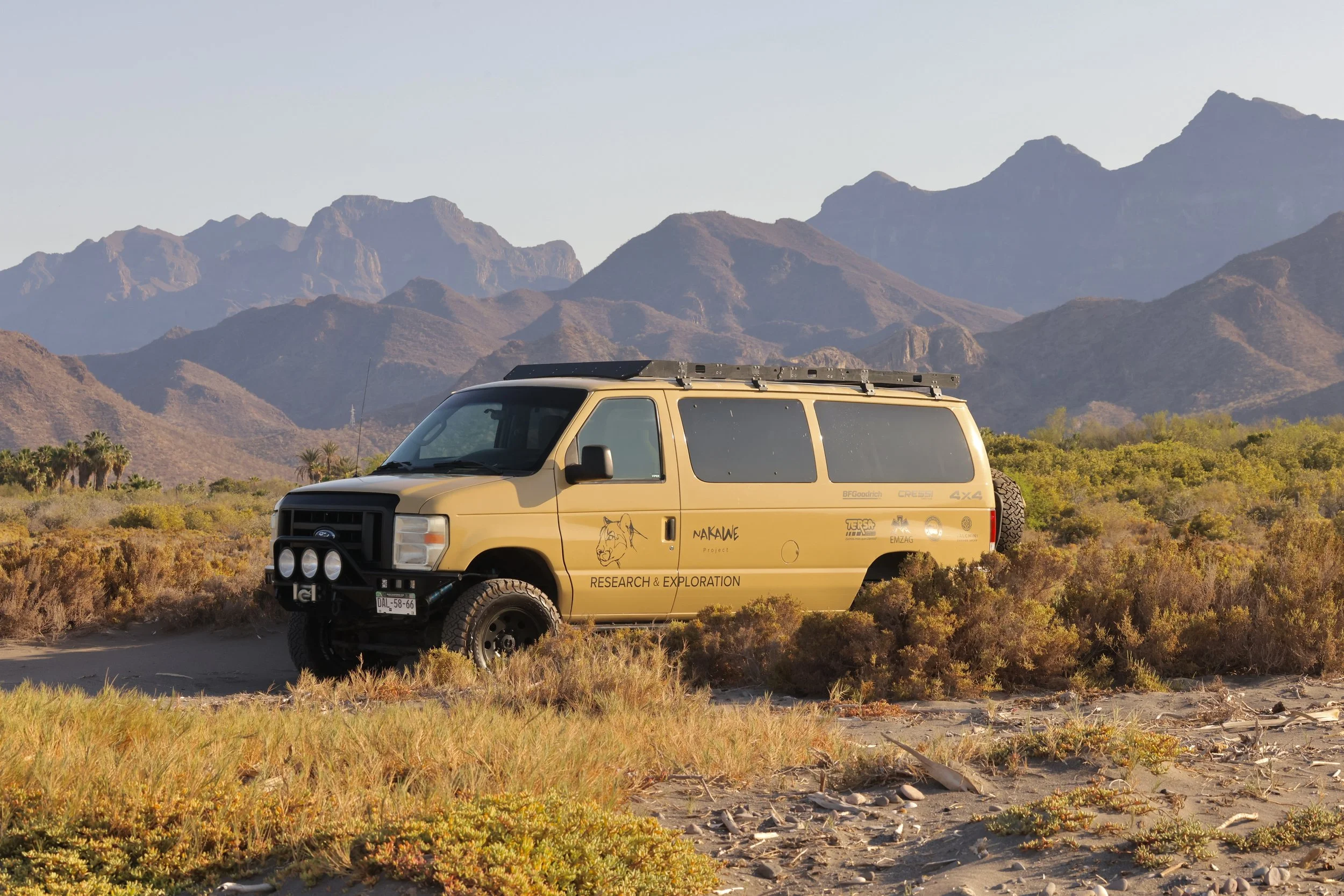 Baja Adventures off-road vehicle parked on desert terrain with mountains in the background, Loreto, Baja California Sur, Mexico