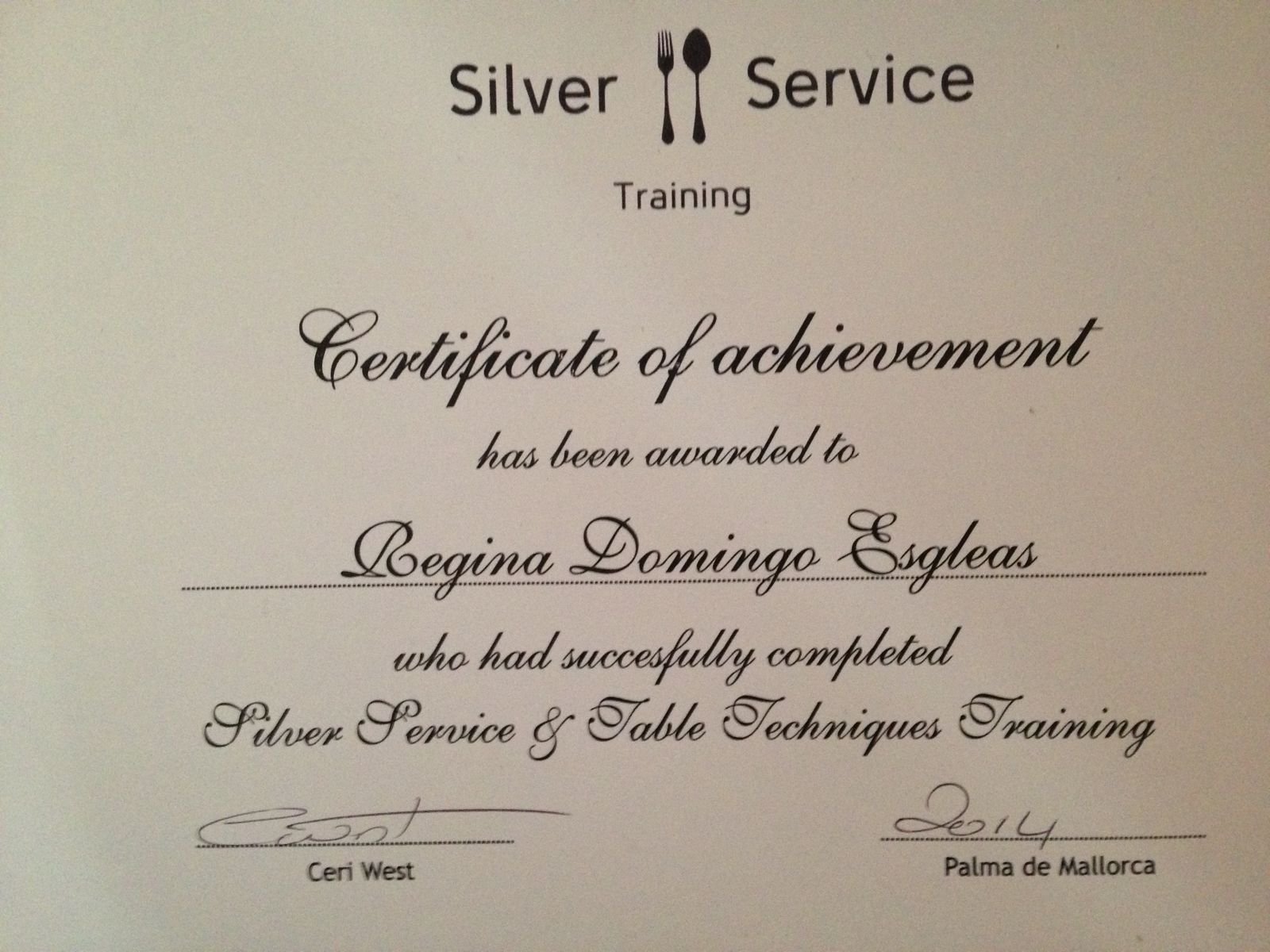 Certificate of achievement awarded to Regina Domingo Esgleas for completing Silver Service & Table Techniques Training, signed by Ceri West in 2014, in Palma de Mallorca.