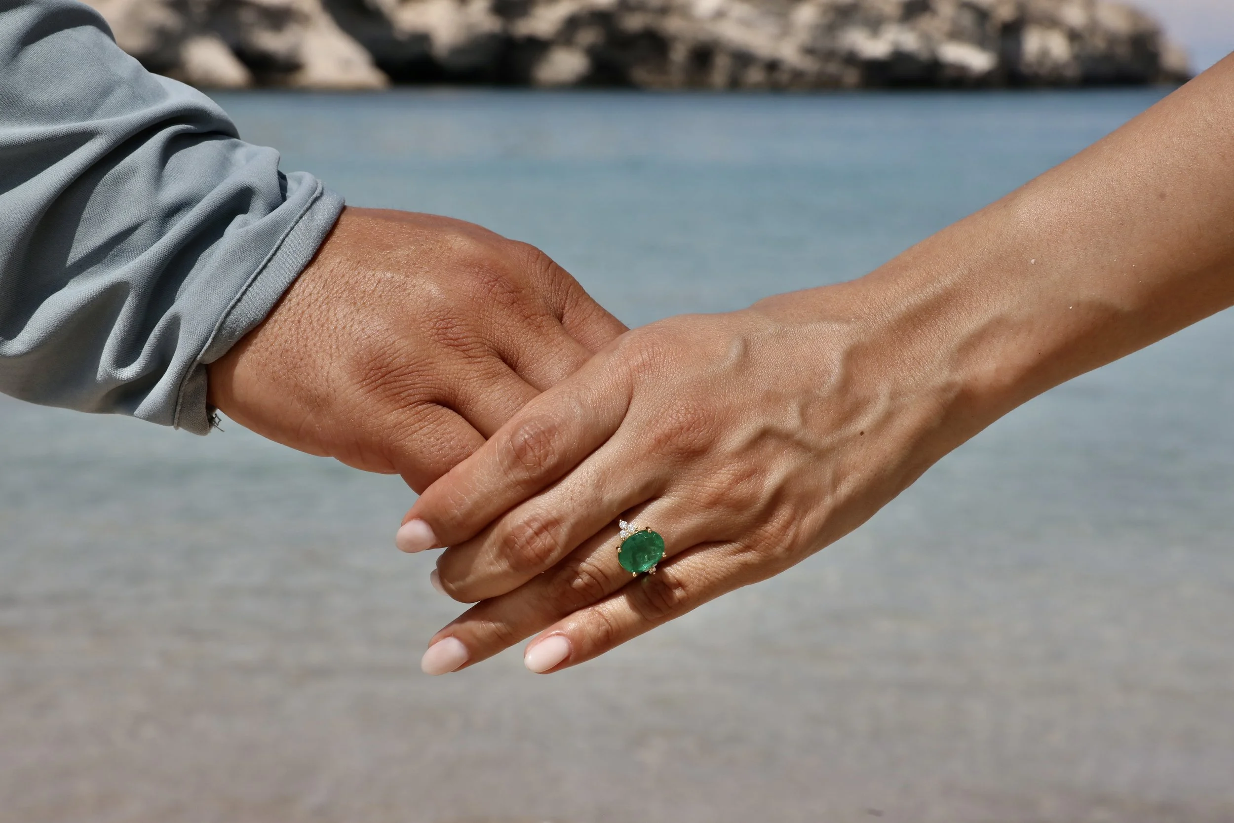 Couple enjoying an intimate proposal beside crystal-clear turquoise waters near Loreto's islands.