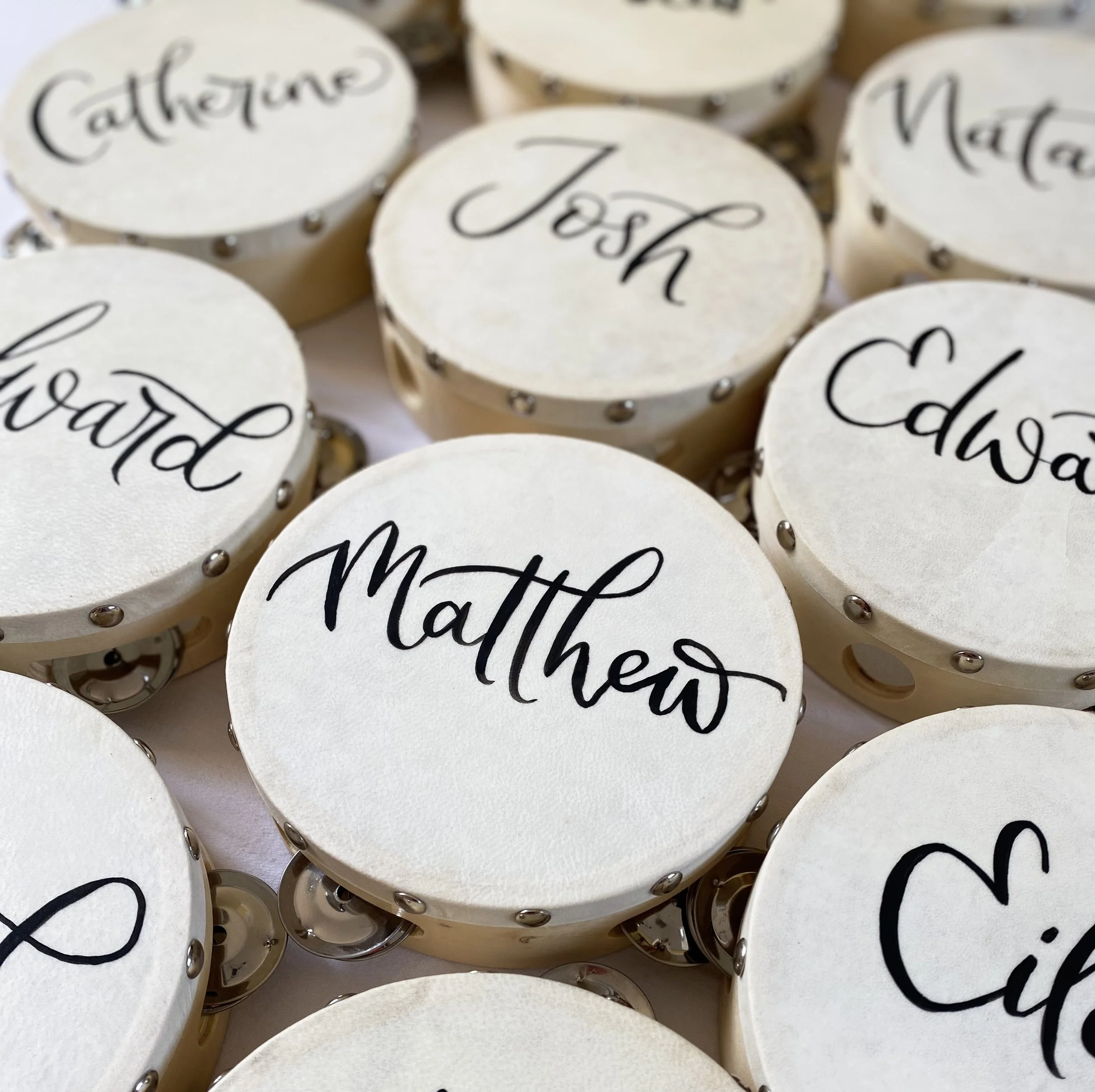 Tambourines with calligraphy names painted on them for wedding guests