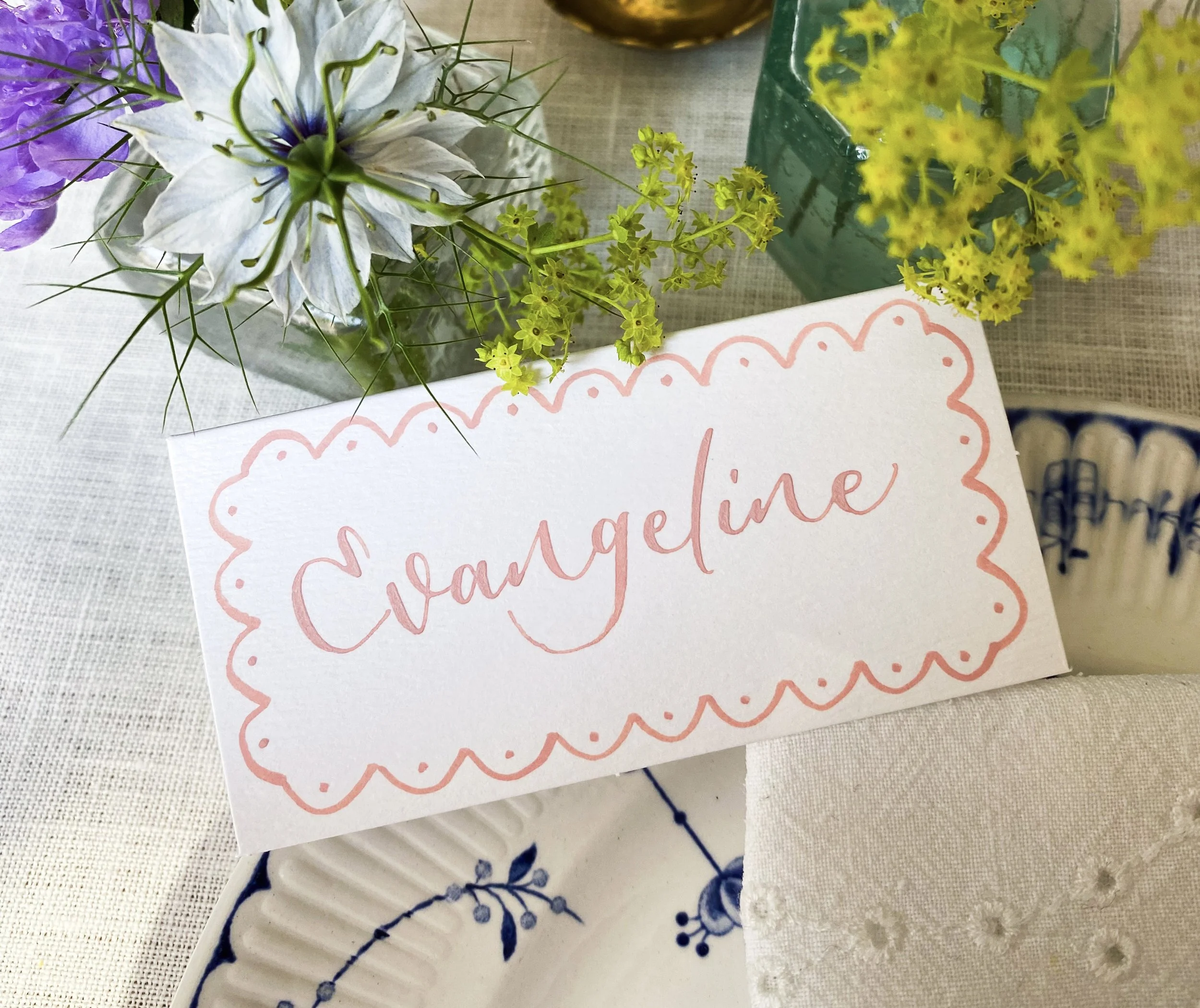 Pink modern calligraphy with a decorative painted edge of scallops and dots