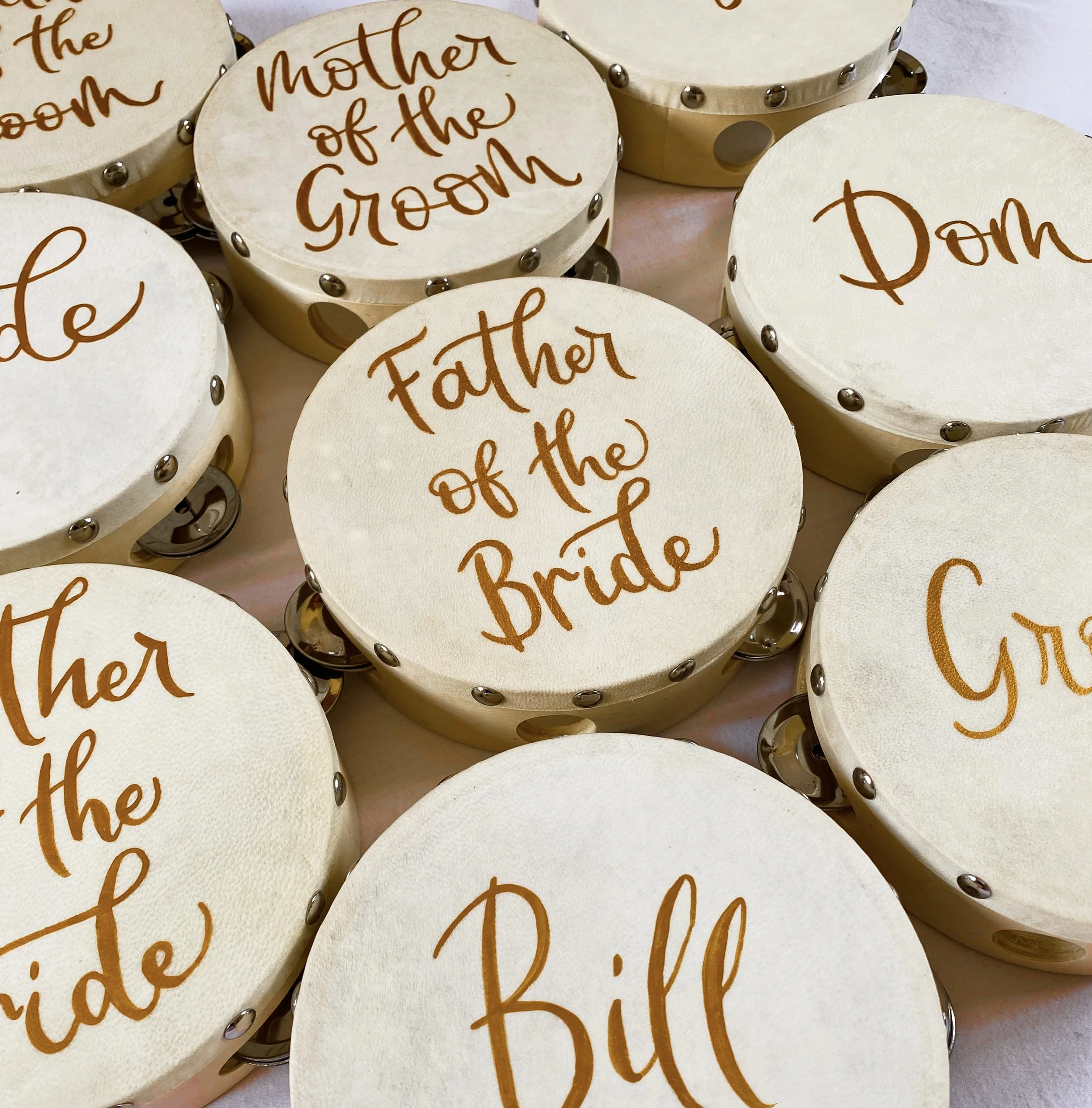 Wedding tambourines painted with guest names in gold