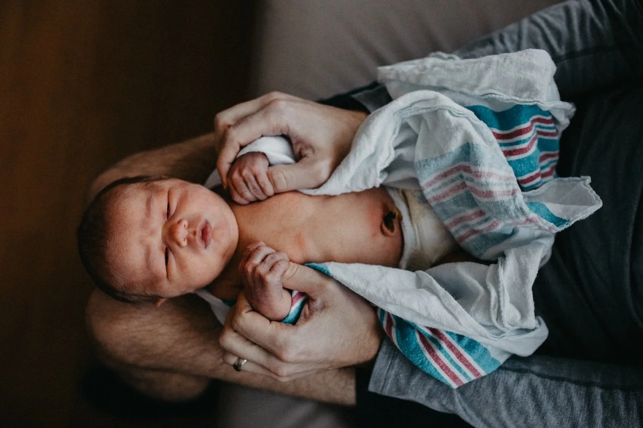 Mother and father holding their newborn baby during a Cleveland Fresh 48 hospital photography session