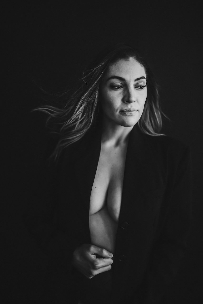 A sexy portrait of a woman in a black blazer in a Cleveland downtown studio.