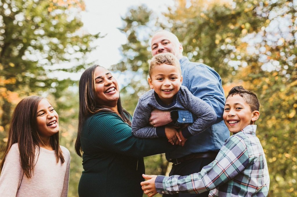 A family having fun with three kids in Orange Village Park. 