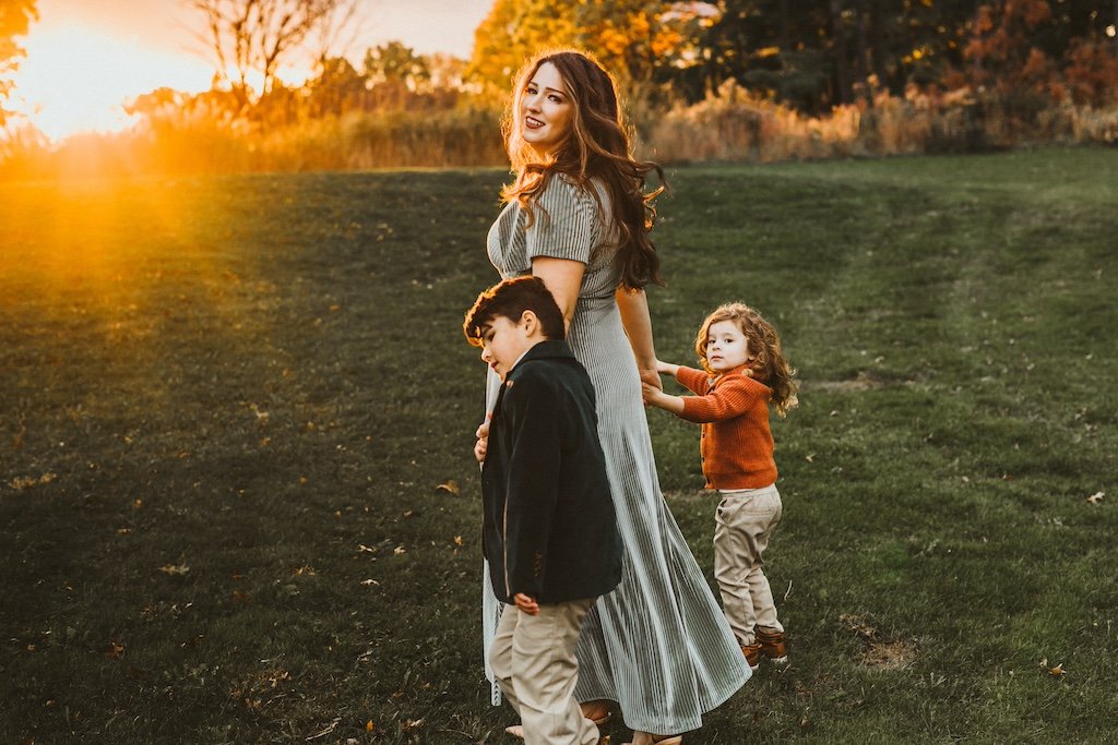 Golden hour session in Beachwood Acacia Reservation with mom in long dress and two boys.