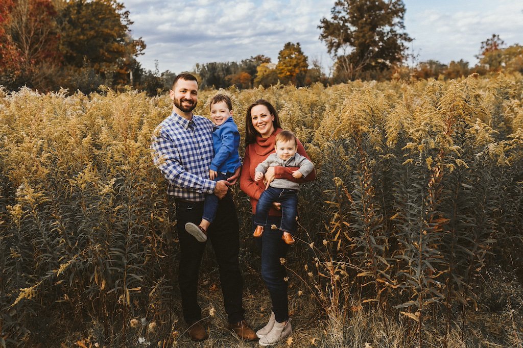 A family posing in-front of goldenrods in Acacia Reservation of Cleveland. 