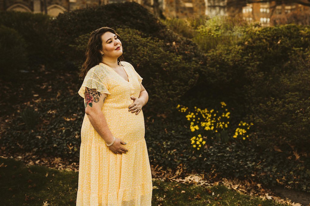 Pregnant woman with closed eyes posing for maternity photo in Wade Lagoon, Cleveland Ohio. 