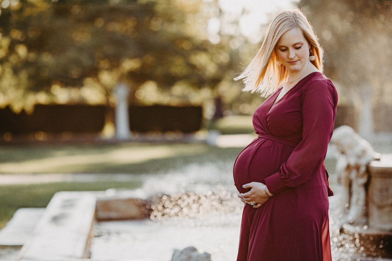 Pregnant woman in front of fountain in Wade Lagoon near Cleveland, Ohio.