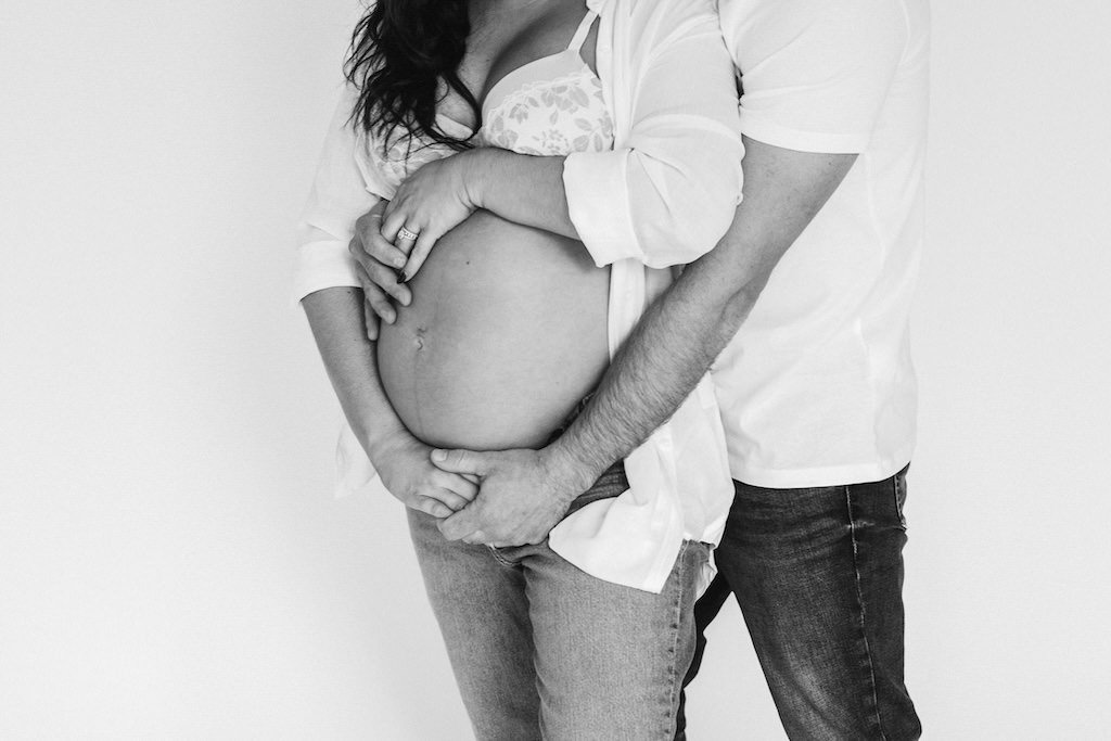 Up close picture of baby bump on mother in photography studio of Cleveland, Ohio. 