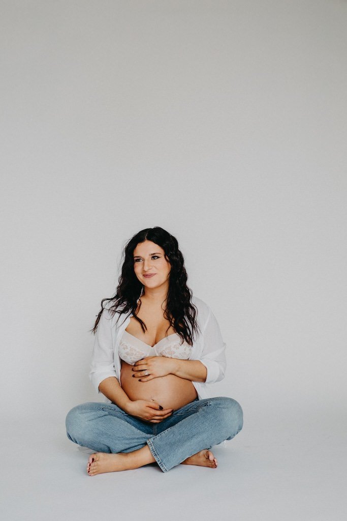 Pregnant mother wearing casual outfit for maternity shoot in Cleveland, Ohio photo studio. 