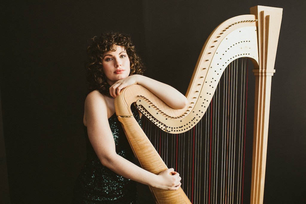 Woman musician wearing gown and posing with musical instrument for branding portraits in Cleveland, Ohio. 