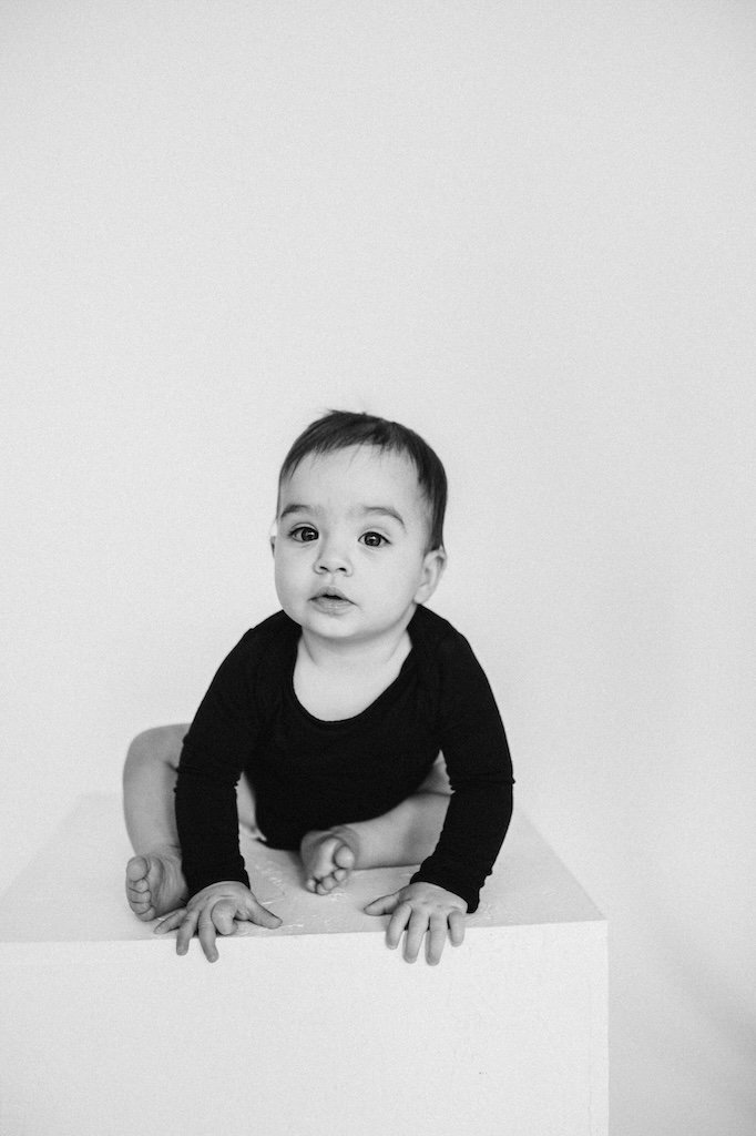 A black and white photo of little girl in black bodysuit in the Cleveland studio.